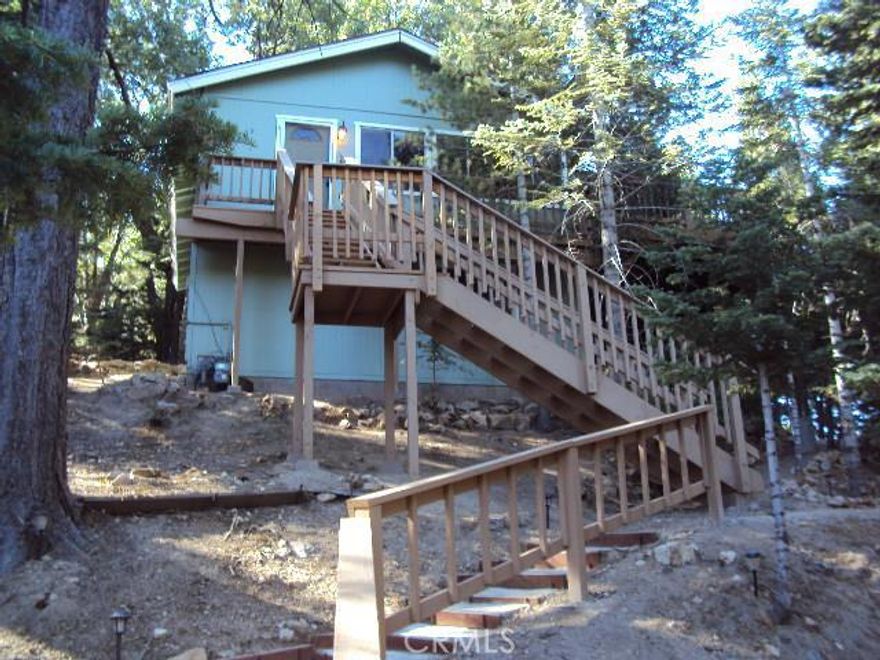 TAKING BACK UP OFFERS----Beautiful quiet mountain retreat, hidden in the pine and cedar trees, describes this gem ready for a new owner to enjoy.  Upstairs features a freshly updated kitchen and bathroom, new carpet, new tile in bathroom and kitchen, wood burning fireplace, open beamed ceiling and a large trex deck for everyone to enjoy.  Down the spiral staircase features another bedroom and 1/2 bath.  Washer and dryer hookups and a large buildup for storage.  Two nice sitting areas and much more!!!!!Lower level bedroom and bath not permitted.