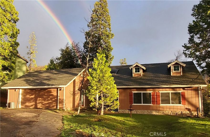Seller to offer credit for rate buy down! This is the perfect mountain cabin at the end of the rainbow! Located near Yosemite, Bass Lake, the Sierra National Forest, and the Sierra Vista Scenic Byway, this home is perfect for outdoor enthusiasts of all kinds, or those who just want to escape the summer heat of the valley, or enjoy a bit of winter snow. This adorably updated hillside cabin has a bedroom/bathroom on each of its 3 levels, with a big back deck looking out over mountain views, a cozy propane woodstove, and the lovely rushing sound of nearby Prohibition Creek rising up from below. Wood floors, a skylight in the master bath, a wonderful window over the sink, an island kitchen, wood beam ceilings, and a lovely private wooded and mountain view out the back are just some of the things you'll love. The main home is 2br/2ba, with a 1br/1ba suite downstairs with a separate entrance from the back of the house. The lower level has a remodeled bathroom with two partly unfinished rooms, perfect for creating an attached apartment with a little work, or use it as a yoga, art, or music studio, or a home work space. The main entrance is on the 2nd story, which is level with the front of the house, and upstairs is a large lovely master suite with a skylight in the bathroom. The kitchen, dining room and living room are on the main entry level (2nd floor). Located in Cascadel Woods, the home is at a higher elevation for cooler summers, and surrounded by USFS lands with trails, waterfalls, swimming holes and more! This neighborhood is in an expired HOA, and the County now maintains the 40 acre greenbelt (with pond, trails and swimming holes in Whiskey Creek, and the rustic clubhouse), paid annually in taxes for a nominal fee. Neighborhood roads are maintained by the water company.
