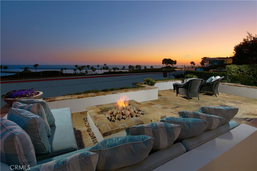 Commanding unimpeded views of the Pacific Ocean, coastline, Catalina Island, and Newport Harbor, this standout estate offers an unrivaled
coastal living experience. Thoughtfully designed, the residence boasts five sumptuously appointed en suite bedrooms and six-and-a-half baths.
Ideal for entertaining, the living room features a brick surround fireplace and unfolds onto an oceanfront patio through bi-fold doors. A built-in
barbecue and open-air fire pit augment the appeal of this space, primed for unforgettable alfresco gatherings. Extending from the secondary living
area via French doors, an interior patio serves as a private haven with a soothing water feature. A chef's delight, the kitchen boasts a center island,
granite countertops, quartz backsplash, Wolf appliances, and custom cabinetry. Two expansive primary bedrooms grace the interiors, one of which
enjoys an ocean view and offers a private balcony, indulgent soaking tub, vanity area, and a spacious walk-in closet. An office, occupying the third
floor, presents the potential to transform into a sixth bedroom. Adding to its allure, it opens onto a rooftop deck, offering resplendent views and an
above-ground spa. Additional highlights include wood flooring, recessed lighting, plantation shutters, and custom window coverings. The property
is completed by a three-car garage and is set just moments away from Corona del Mar’s village shops, restaurants, Fashion Island, Lido Marina
Village, and award-winning schools.