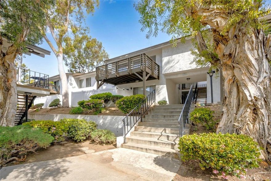 DISCOVER COMFORT & CONVENIENCE IN THIS BEAUTIFULLY DESIGNED 1-BEDROOM CONDOMINIUM PLUS A HIGHLY DESIRED BONUS SPACE AT 1200 W LAMBERT ROAD #34 IN THE CHARMING COMMUNITY OF WOODLAKE VILLAGE! This home is situated in a rare interior location with a delightful view of the sparkling pool and a serene environment surrounded by mature trees. Step inside the inviting living room and appreciate the new plush carpet, new interior paint, smooth ceiling, recessed lighting, and new ceiling fan. This thoughtfully designed floorplan includes additional living space with a large closet and a vaulted & open beam ceiling, that can be used as an office, den, or easily converted into a 2nd bedroom! The dining room & kitchen boasts gorgeous new luxury vinyl plank flooring & substantial natural lighting, sleek granite countertops, ample cabinetry, a new 5-burner gas stove, and quality stainless steel appliances. Step into the spacious owner's suite and find new plush carpet, recessed lighting, a walk-in closet, and a remodeled & stylish full bath with a granite countertop and new toilet. Additional features: Gorgeous upgraded new flooring throughout, new neutral interior paint, smooth ceilings, recessed lighting, and central heat & air conditioning. Enjoy outdoor living and entertaining on your private balcony, ideal for morning coffee, dining under the stars, and overlooking the lovely pool and well-maintained community.  As part of Woodlake Village, you will have access to fantastic amenities, including two sparkling pools, outdoor barbeques, meandering walking paths, 1 covered parking space with storage,   and low HOA fees including water, trash, and gas utilities. Woodlake Village is conveniently located in a highly desirable and wonderful neighborhood, near top-rated schools near top-rated schools, dining, parks, and easy freeway access. Welcome Home!