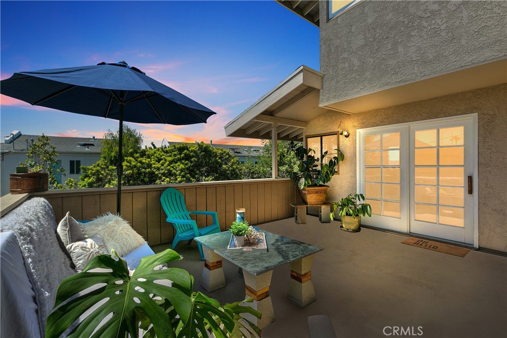 Accepting Backup Offers. Dreaming of a home where you can simply move in and relax? This bright and modern Dana Point residence near the beach has been tastefully updated and is presented in immaculate condition just waiting for you to enjoy! Step inside where recessed lighting and an abundance of natural light combine to illuminate the tasteful tile floors that flow underfoot throughout the open layout. A beautiful stone fireplace warms the living room for a cozy ambiance to relax in on cooler evenings. Your adjacent eat-in kitchen is well sized with all-white cabinetry and stylish granite countertops for an enjoyable environment to cook delicious meals in. You’ll have two large bedrooms to unwind in after a long day where hardwood-style floors and fandeliers are on show for comfort. As a bonus, relish peekaboo Pacific Ocean views from one of the bedrooms and the living room.
Out a sliding glass door, there’s an oversized patio where you’ll love entertaining guests while ocean breezes cool you down on warm summer days. Additional features include a laundry room with shelving and a two-car garage for convenient parking. You’ll be ideally located just moments from Doheny State Beach and close to parks, golf, and many shopping and dining options. Plus, Highway 1 and the I-5 aren’t far for easy commuting. Your SoCal dream life awaits in this lovely beach townhome, so come treat yourself to the life of leisure you're craving