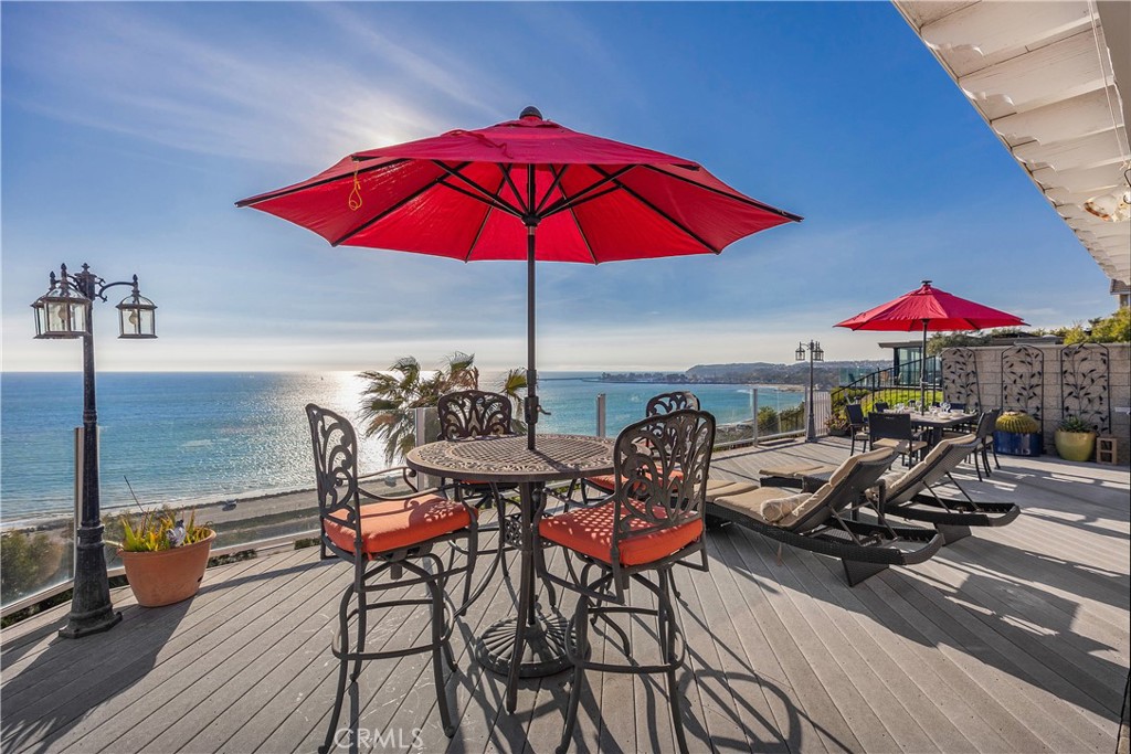 **Property is currently rented; available starting August 10th, 2025**. Available for monthly or annual lease, this furnished 4-bedroom, 4.5-bathroom oceanfront residence in Dana Point offers a unique opportunity for luxury living. Situated on the bluff with unobstructed panoramic ocean views, the home combines elegant design with comfort, creating a serene coastal retreat. The main level features a well-appointed gourmet kitchen, seamlessly connecting to the dining and living areas, providing an inviting space for both relaxation and entertainment. A private guest bedroom with an ensuite bathroom and a powder room complete the main floor. Upstairs, three spacious bedrooms offer mesmerizing ocean views, with the primary suite serving as a tranquil haven, featuring a king-size bed, lavish ensuite bathroom, and a private balcony overlooking the Pacific. Additional bedrooms include a queen bed in the second guest room and a queen bed paired with a twin bed in the third bedroom with a private ensuite. A secondary hallway bathroom is also available upstairs. Practical amenities such as a washer and dryer add convenience, while central air conditioning ensures comfort year-round. The ground-level patio offers a perfect setting for alfresco dining or unwinding against the backdrop of the ocean. With ample parking in the expansive driveway and a prime location minutes away from major grocery stores, restaurants, Dana Point harbor, and Southern California's finest beaches, this ocean bluff home combines convenience with coastal living. Embrace the opportunity to lease this stunning oceanfront residence and experience coastal luxury living at its best.