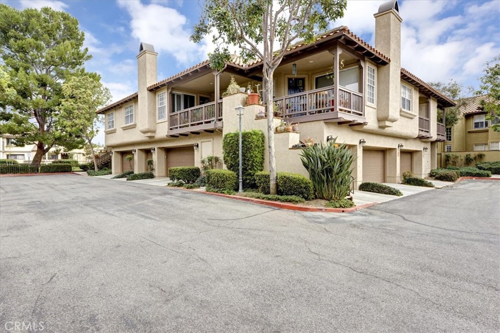 Welcome to a Charming Home, located in the beautiful community ,The most sought after plan condo in ARCADA community. Two car garage attached to kitchen , first floor end unit , private entry , two large size private patios , plenty of natural light with views of green belt from all the windows . oak wood floors. Fresh paint through out the house and garage. Apoxy garage floor with plenty of storage. Nice fireplace . Access to the Community Pool and Shop and Restaurant. Close to Tustin Market.