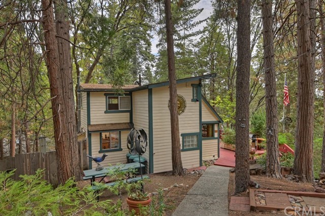 The classic mountain charmer you have been searching for! Built in 1928 and resting within 3 parcels(Lots 38,39,40) offering the most tranquil mountain settings. This property is oozing with vintage mountain retreat ambience from a era gone by. Top to bottom interior knotty pine T&G. Cozy living room with open beamed vaulted ceilings and floor to ceiling stone fireplace. Master bedroom and full bath on main level! Kitchen offers stainless appliances and direct access to a private lounge deck, perfect for morning coffee. Upper level can serve as 2 bedrooms plus full bath, or 1 bedroom and home office area. Massive entertainers front deck, great for entertaining guests while overlooking the grounds. A rare find in the mountains, level back yard area with horseshoe pit and partially fenced dog run area! Landscaped with Chartreuse Japanese Maple, Apple and Small Cherry trees. Rhododendrons, and Perriwinkle Vinca ground cover. Level parking for 2+ cars, make this a must see!