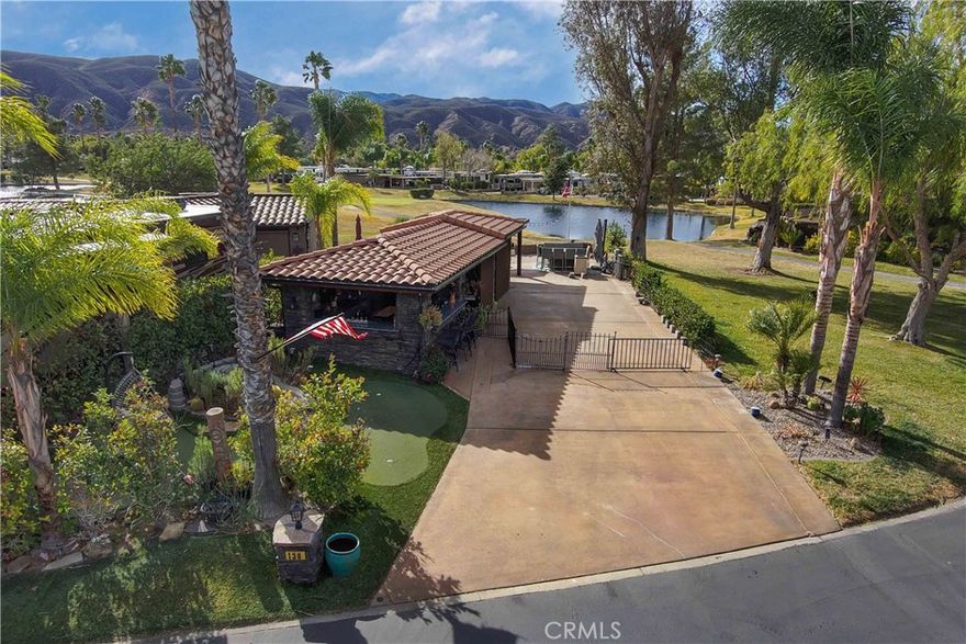 Here it is, the one you have been waiting for... Such a Cute place with a Fabulous View of the Water, Golf Course, Mountains and Sunsets. Front Private Entrance has a 4 hole putting green with a Waterfall Pond and Hollywood Hedges that are perfect addition to the Belly up Bar Entertainment Island overlooking the Kitchen with Granite Counters, reverse osmosis drinking water, Fridge & Freezer, Hot water heater, Stove & Oven and 65 in TV on Fireplace Table and dark cabinets. The access to the fully screened Tile Roof Buildout & Gutters with extended Allumawood cover and has 3 Screen slider entrance Open Beam Ceilings, Stacked Stone walls and Pillars with a Dining area with step up Family room with 65 in TV and Gorgeous Wood looking Tile throughout. Outside has Old World Stone Blocks, Stained Concrete Pad with Gate to the Grassy Knoll and large common area space on the west side of property with dog fence that surrounds the property. Included in Rancho California RV Resort is a 14 hole Executive Golf Course that is unlimited play, 5 Pools and Jacuzzi areas, Tennis Courts, Pickle Ball Courts, Laundry Rooms, Dog Park, Horse Shoe Lawn, Club House, Hiking Trails, and Restaurant all inside Gated Community that is Guarded 24/7. You can live here or rent your space. Peace and quiet serenity all just 25 minutes from Temecula Wine Country. No age restrictions. Financing Available... Come on over and check this hidden gem of a place out...
