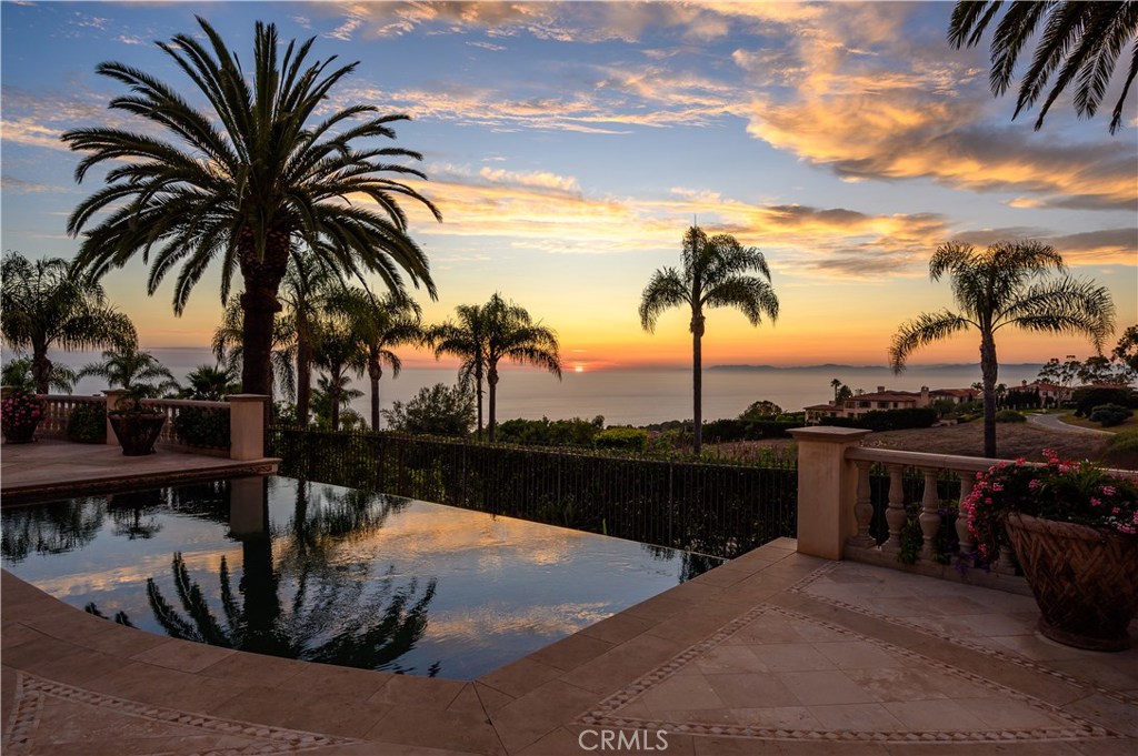This lush Tuscan Villa is a classic estate with dramatic ocean and sunset views, gorgeous facade, manicured grounds with dozens of mature palm trees, travertine pool deck, sports court & more. The drama begins from the onset at the beautiful wrought iron driveway gate with the garden, fountain & ocean in the background as you approach the entry down the long driveway. Finally, you’ve arrived at the circular motor court made from stone excavated from the site itself. Step through the wrought iron front doors framed by unyielding stone columns & archway into the well designed 9,500 sf home. The house features 5 bedrooms, 8 bathrooms, library, media room, gym, office, wine cellar, pool, sports court, putting green, balconies, outdoor kitchen+dining area & fire pit. The entry level has an open floor plan showcasing the views w/family rm-generous kitchen- breakfast nook and 5 car garage & French doors to the outside- ideal for routine living & hosting. Also on the main level: dining & living rm, media rm, library & guest bdrm. The upstairs features the master wing + 3 big en-suite bdrms all with ocean views. The master wing features a luxurious bathroom & huge walk-in closet w/center island. Other features: 3-stop elevator, basement w/gym, full bath w/steam shower + sauna, wine cellar, French limestone, custom wood floors, premier carpentry, venetian plaster & faux paint. The views & overall complexion make this one of the most high quality & timeless homes constructed in PV.