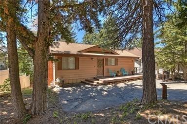 Welcome to Nob Hill where panoramic views surround you, hiking trails invite you and the central location takes you easily to Lake Arrowhead or Big Bear. This lovely homes sits on a gently sloped lot with plenty of parking & room for a garage, toys or RV. The main level features the living room with an open beam ceiling & brick fireplace, the kitchen, dining area, & master suite. There are beautiful hardwood floors throughout the main floor (excluding the hall and master suite). From this level there is access to the large rear deck to enjoy the sunset as you barbecue. Downstairs is the laundry area, 2 more bedrooms & the remodeled bath with shower. There is also a large build up area which is accessible from inside on this level as well as a rear patio. The lot is large & sunny and offers lots of opportunities for gardens or play areas. You'll love the beautiful view of the valley & city lights from the backyard! Easy year round access too!