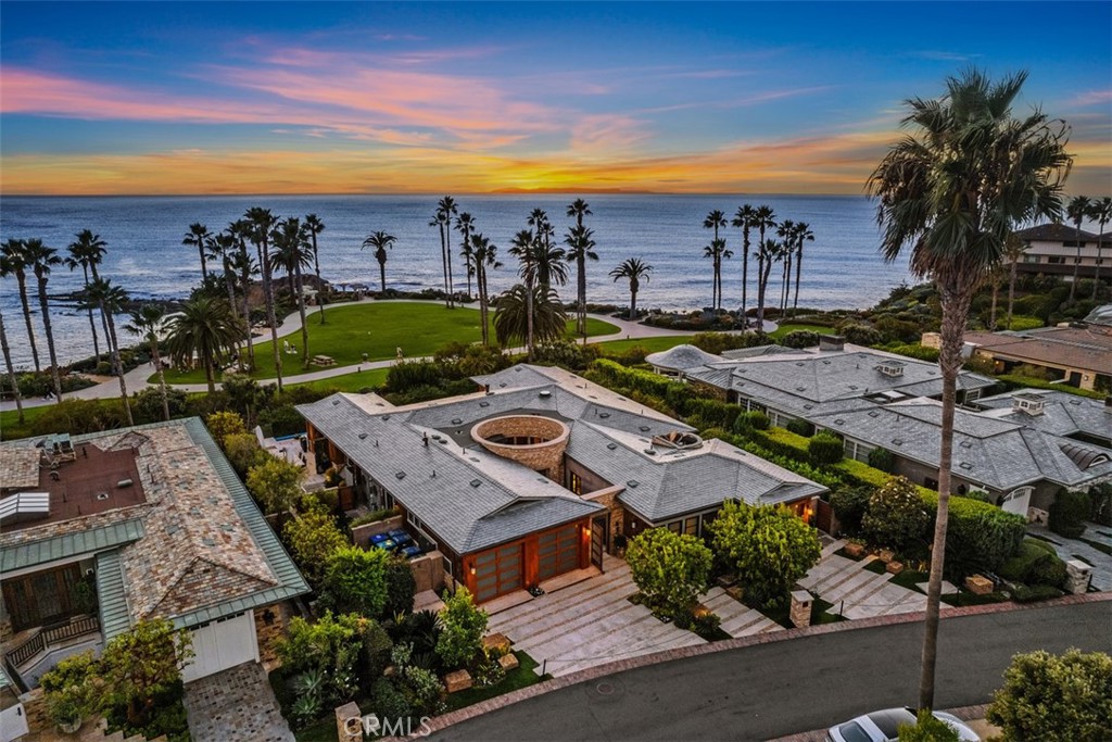 Front Row Center Stage. Step into the lap of opulence with this exquisite oceanfront masterpiece, perfectly situated in the front row of the ultra-exclusive Montage Ocean Estates, a sanctuary of unparalleled luxury. Be entranced by the awe-inspiring panoramic views of the boundless Pacific Ocean and the resplendent Catalina sunsets that grace every corner of this expansive, open-concept haven. Each element, every material, and all finishes in this residence have been painstakingly handpicked, drawing inspiration from the most elite worldwide sources. Marvel at the custom ocean-inspired mahogany ceilings that adorn the living room or run your fingers across the exquisite backlit onyx kitchen countertops in the kitchen. Admire the custom wood-set walls, the delicate abalone shell inlays, and the interior design, thoughtfully curated where cost was of no concern. Notice the rich wooden wall coverings throughout the estate handmade to order by Maya Romanoff. This residence is a symphony of elegance, where walls of glass seem to disappear to bring the outdoors in, revealing a world of top-tier features and finishes that seamlessly merge with the lush outdoor surroundings. Immerse yourself in the garden-like oasis that boasts a PebbleTec infinity-edge pool, a Lynx outdoor BBQ, refined wet bar, and a tranquil Zen atrium adorned with custom waterfalls and natural rock features. The luxuries continue to unfold within this opulent estate, including a meticulously climate-controlled wine room with space for several hundred bottles, an indoor-outdoor atrium crowned above by a custom glass ceiling, radiant heated floors for your utmost comfort, and an ELAN smart home system that caters to your every whim. Ascend the custom artistic stairwell to discover a master bathroom that rivals the most sumptuous spa retreats, and a home theater boasting a 9-screen TV setup for unparalleled cinematic experiences intensified by a Sonos sound system. To elevate this extraordinary opportunity to the pinnacle of exclusivity, luxuriate in the unparalleled access to the 5-star resort “a la carte” amenities offered by the prestigious Montage Laguna Beach, all while reveling in the utmost privacy and comfort within your own sanctuary. This is not merely a property; it's a masterpiece where luxury meets the extraordinary, where the beauty of the ocean converges with the essence of elite living. Welcome home to the life of unrivaled refinement and prestige that you've always envisioned.