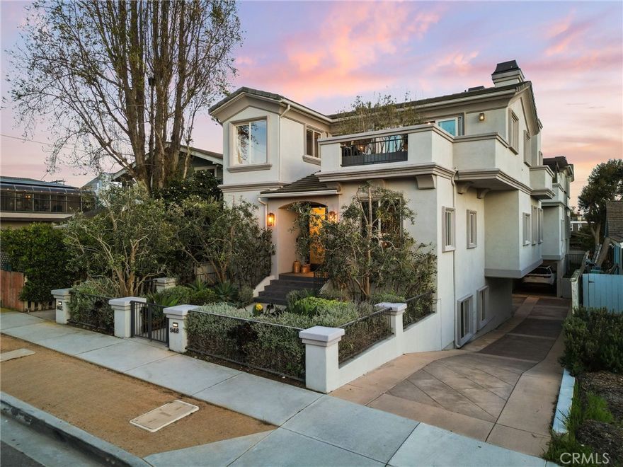 Introducing a truly exceptional 5-bedroom, 4-bath residence in Hermosa Beach, where thoughtful design and laid-back elegance come together in perfect harmony. Designed by Tim Clarke with a “Soho at the beach” inspiration, this expansive home blends traditional and contemporary elements, incorporating vintage touches, rich textures, and curated details that celebrate its coastal setting. From carefully selected color palettes and designer wallpaper to statement light fixtures and a stunning exposed beam in the main living area, every detail reflects Clarke’s refined aesthetic and hands-on involvement.  Upstairs, stunning ocean vistas frame the open-concept living space, where a chef’s kitchen with a large center island and integrated high-end appliances flows effortlessly into the main living and dining areas. Step through sliding doors onto a serene front patio or head to the rear terrace, designed for al fresco cooking. From there, ascend to the rooftop deck where views, sea breezes, and sunshine complete the picture.  The main level features a spacious and tranquil primary suite with a walk-in closet and spa-like ensuite bath with a standing tub and dual shower heads, along with two additional large bedrooms, a guest bath, and a laundry room. On the lower level, two more bedrooms—including one with its own ensuite bath—offer the perfect setup for guests or extended family.  Tucked into a quiet residential street just minutes from the sand, downtown Hermosa, and award-winning schools, this home offers a rare opportunity to live in a thoughtfully curated space that feels both effortlessly stylish and unmistakably Hermosa.