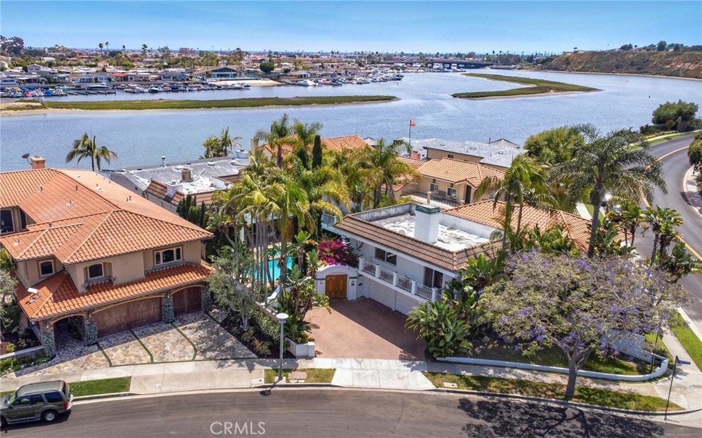 507 Morning Star is situated in the highly sought after community of Dover Shores along being on one of the larger bay front lots. Panoramic views of Fashion Island, Back Bay Hillsides and the glistening waters of Newport Beach. As you enter through the gated courtyard that reveals a beautifully private landscaped entertaining area with a pool and spa. Entering the home, you come through a formal entry leading into the living room. Downstairs has a massive Living room that looks over the water, with deck that runs the full length of the home for entertaining, along with fireplace then into a large family room with wet bar, also overlooking the water. Large dining room, kitchen, laundry room and bedroom with an on suit. Upstairs has 4 bedrooms, one large enough to be a secondary primary with an on suit overlooking a deck, courtyard and pool/spa. The Main Primary Bedroom Wing includes water views from a walk out deck that runs the full length of the home with spectacular views, along with a fireplace, formal bath, and large office that also includes a fireplace. 2 other bedrooms overlook the water as well and have access to the deck. The home includes an approximately 748 sq. ft., 1 bedroom, 1 bath ADU unit over the 3-car garage with a fireplace. The property has a boat slip that will accommodate 3 larger vessels with permits for being completely updated. Close to outstanding schools, shopping, restaurants, John Wayne airport. Great property to make this home what you want it to be.