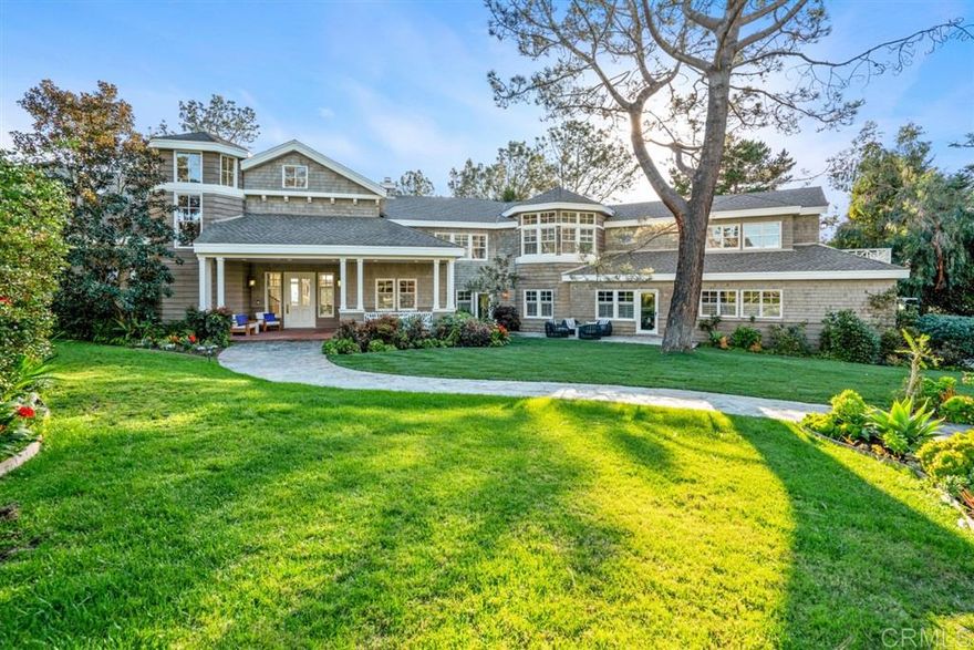 Custom Hamptons style trophy estate situated on a gated one acre ocean view parcel. Remodeled in 2020, this 8005 SQFT 6BR/6.5BA residence will knock your socks off. Nature surrounds the property and serene patios and a solar heated infinity edge pool offers a perfect set up to enjoy the best of coastal California living. Aesthetically pleasing in every regard, the formal living and family rooms feature voluminous, vaulted ceilings and a wall of windows allowing uplifting natural light to stream in. The generous main floor master retreat is privately situated away from the secondary bedrooms, providing an amazing space and spa-like bath in which to unwind at the end of a long day. Fun awaits in the game room conveniently located off the chef grade kitchen and open concept great room. Wood burning fireplaces frame the space and imported reclaimed maple hardwood flooring lines the home. The upper level houses 5 secondary bedrooms, 4 full baths, as well as a library loft space and office with breathtaking views of the Pacific Ocean. Storage is abundant throughout and parking includes a 3-car garage with electric charger, plus a tinkerer's dream workshop. Conveniently located, beach access, award winning schools, the conveniences of Del Mar Village, and I-5 access are all available within 5 minutes.