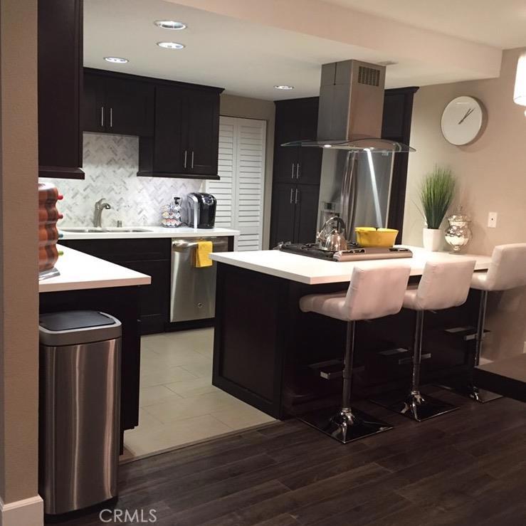 GORGEOUS! Contemporary, remodeled three bedroom, two bath condominium. This beautifully remodeled condo boast of luxurious upgrades throughout. Spacious modern kitchen features espresso shaker cabinets, quartz counters, marble herringbone tile backslash, porcelain tile floors, and bar stool seating area. Top of the line GE stainless steel appliances, dishwasher, slide in gas range, and island range hood. Open concept dining room features a gorgeous crystal chandelier, scraped ceiling with recessed lighting, 6” high base boards and modern grey laminate flooring that leads to the spacious open Living room area. Master bedroom suite has upgraded mirror closet doors, grey laminate flooring and high base boards with remodeled attached en-suite bathroom. Master bathroom features porcelain tile floors, and subway tile tub surround walls. Two spacious guestrooms with recently installed carpeting. Central air and heating, and laundry hookup in kitchen. Condo complex offers great amenities including low monthly HOA dues, secured entry with intercom, elevator, secured gated 2 assigned subterranean parking spaces, recreation room, gym, sauna, and a bike storage room. Located on the Eastside of beautiful Long Beach close to shopping, restaurant, beaches, and CSULB.