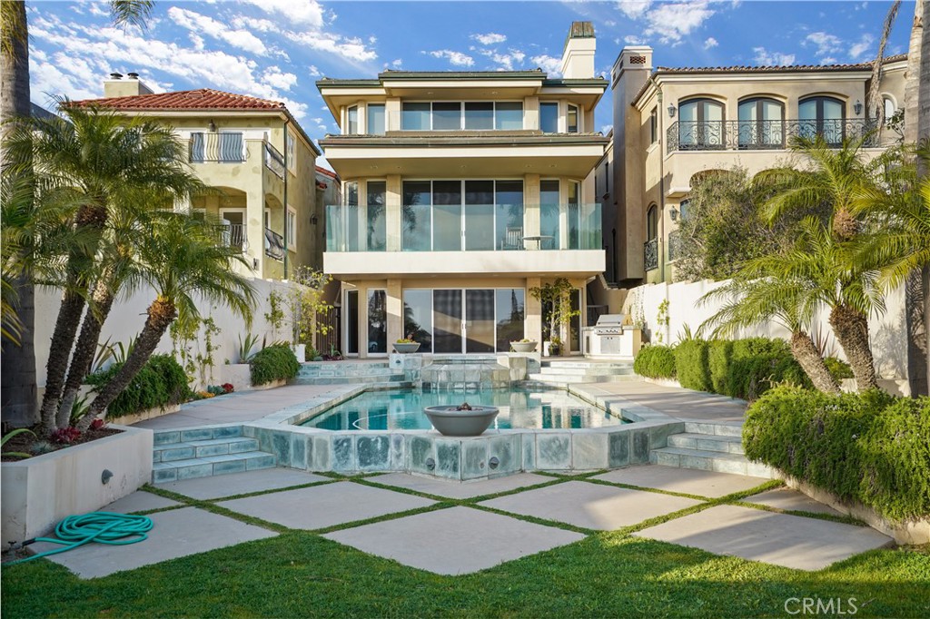 Seal Beach Gold Coast home with amazing views in every direction does not get better than this. Once in a lifetime opportunity to acquire a contemporary 3 story home with amazing layout that takes full advantage of the views and the slope of the lot. Over 5,380 square feet of living space on a 6,860 square foot lot right on the sand. Views from every level, open concept, 5-bedroom 7-bath, office, floor to ceiling glass, amazing architectural design, workout room, elevator, gym, pool, spa, yard, built in outdoor kitchen with access to the beach. These opportunities rarely come along. Top floor features master with endless ocean views, huge covered deck, master bath, walk in closet and attached office. There are also 2 additional bedrooms both with on suite bathrooms and a laundry room. 2nd floor features expansive living room, entry and kitchen all open with ocean view and large deck. Bottom is an entertainers dream with living room with full kitchen opening to amazing back yard, additional bedroom with on suit bath, library and media room/gym, additional full bathroom. Homes like this never come on the market there are only 44 homes on the sand west of the Pier in the Gold Coast of Seal Beach. One of the best places to live in Southern California walking distance to main street and right on the sand. Call for private showings