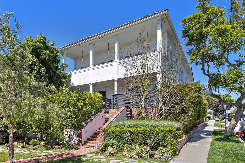 Perfectly blending modern luxury and coastal comfort, 2220 Waterfront Drive presents 3 bedrooms, 4.5 bathrooms, multiple outdoor spaces, ocean views, and a central location. Every detail has been carefully considered, from long plank oak wood floors to custom paneling, built-ins, open living areas that extend into indoor-outdoor spaces, and smart features such as automatic shades and Yamaha surround sound in every room. The first floor presents a Dutch door entry, powder room, full bath, living room with fireplace, kitchen, dining area, large bonus space that can be used as an office nook, and garage access. The kitchen features custom cabinetry, generous pantry space, double wine fridge, built-in ice maker, high end appliances including a Sub-Zero fridge and Thermador range and oven, and an island with double-sided bar seating. The upper level of the home offers an additional office space, a living room or media room, and three bedrooms and bathrooms including the primary suite. Exuding elegance, the primary suite presents its own fireplace, private balcony, and a massive en suite bathroom with dual sinks and vanities, freestanding soaking tub, and separate glass walk-in shower. A fourth bedroom has been converted into a spacious walk-in closet for the primary suite, complete with built-ins and center island, and can be easily converted back. Combining privacy, relaxation and entertainment, the outdoor spaces include an elevated front deck with a fire pit, covered patio with a water feature, the primary suite balcony, and an impressive 495 sq ft rooftop deck with spectacular views spanning from Fashion Island over the Newport Harbor to Catalina Island, capturing the Pacific Ocean and city lights. Engineered to accommodate a spa, the rooftop deck also includes an outdoor kitchen with a sink, fridge, additional storage space, BBQ, fire pit, and a large umbrella with heaters. Rounding out the amenities, this elegant home offers a full laundry room with washer, dryer, laundry chute and sink, central A/C throughout, tons of closet space, and a two car garage with ample storage and epoxy flooring. With a highly coveted central location, the home is just a short walk to Corona del Mar’s incredible beaches, shopping, dining, and beautiful neighborhood parks. Don’t miss this opportunity to own a fantastic property in one of the most desirable areas of Orange County.