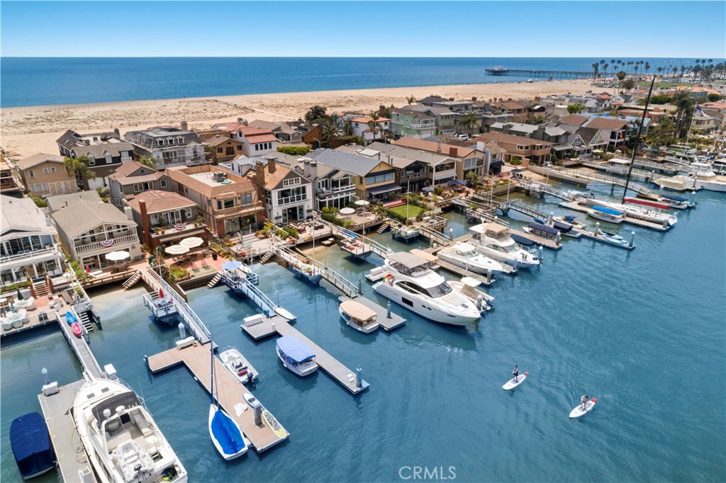 This exceptional Cape Cod-inspired home has an ideal bayfront position, offering unparalleled panoramic views of Newport Bay, while also providing close proximity to the beach and a spacious open floor plan. With clean lines, modern amenities and the finest attention to detail, this immaculate property was designed by Brandon Architects and recently completed in 2018 by premier homebuilder, Spinnaker Development. The custom luxury residence has a soothing neutral palate of colors. The opulent master suite with balcony has a prominent location highlighting sweeping views of the bay and the peaceful morning sunrise. Two additional oversized bedroom suites; a bonus room; large great room with wet bar opening to the rear patio and dock; an expansive viewing deck at the front of the property with a wet bar; all provide the perfect backdrop for relaxing with family and friends. Discerning finishes are provided throughout: coffered ceilings; custom cabinetry; an elevator accessing all three levels; walk-in pantry, butler’s pantry and beautiful stone, marble and tile work. Exquisite sapphire views are on display from most rooms in this idyllic coastal home. Indoor and outdoor spaces seamlessly blend providing an outdoor fire pit, dining area and built-in barbecue. This is a tremendous opportunity to enjoy the best in bayfront living and the coveted Newport Beach lifestyle with world-class beaches, surfing, paddle boarding, sailing, and dining. https://vimeo.com/404686338