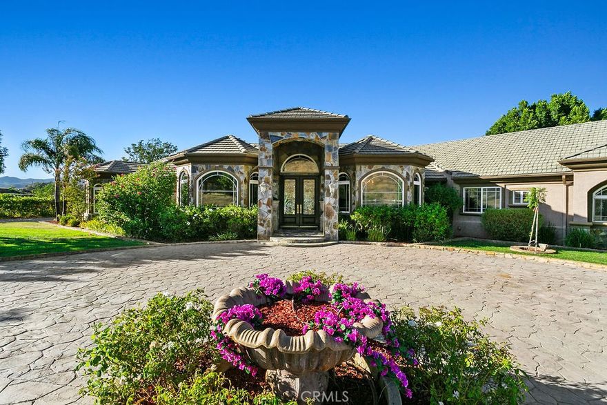 Welcome to “Miracle Ranch” a world-renowned equestrian training facility and luxury estate. Amazing opportunity to own one of the most prestigious panoramic view ranches in sought after La Cresta, high above Murrieta/Temecula, easy access to equestrian shows and events. This Equestrian Dream facility offers even the most discerning buyer an opportunity to have their own personal training center or run a business boarding for trainers and clients. Two separate lots total approx.14.9 acres. One lot can be used for an additional home, indoor arena, further pasture areas or sold off down the road. Enter this completely fenced estate through impressive double entry gates and driveway to a circular courtyard with sprawling single story home on expansive lot. Views from every window, endless lawns, elaborate amusement park type double pool with waterfalls, slides, cave, bridge “Tarzan” swing rope and more. Outdoor kitchen, huge patios and entertaining areas. Enter residence through double beveled glass doors to soaring entryway, beautiful formal living room with cozy custom fireplace and French doors to exterior. Large open floor plan, formal dining room for family parties, and spacious library/office area. Stroll along to massive family room with cozy custom fireplace, built-ins, bay window eating nook and chefs delight kitchen with top of line appliances (Wolf/Sub Zero), central island, breakfast bar and walk in pantry. Three secondary bedrooms and a 5th bedroom upstairs, presently used as apartment with bathroom, kitchen, balcony and more. The lavish primary suite sits in own private wing, offering large sitting area, private deck, double closets, soaking tub, and shower. 4/5 car garage completes the residence. The equestrian facilities are unsurpassed. Main mahogany-built barn with European fronts, 8 stalls: 5 stalls 16x20 and 3 stalls 16x16, double doors each end, top of the line finishes, fire sprinkler system, Nelson Auto waterers, speaker system, chandeliers, grooming stalls, utility area. All stalls have mattress flooring, offer exterior open windows with shutters, fans, barn aisle with rubber flooring, fly system, tack room, alarm, cameras office/feed room, lounge, bar, powder bath and viewing deck overlooking stunning 100’ x 350’ arena, Ebb & Flow under footing watering system, GGT footing. Two additional center aisle barns offer 14 stalls each with similar amenities. Total of “36” stalls. See amenities list for additional information.