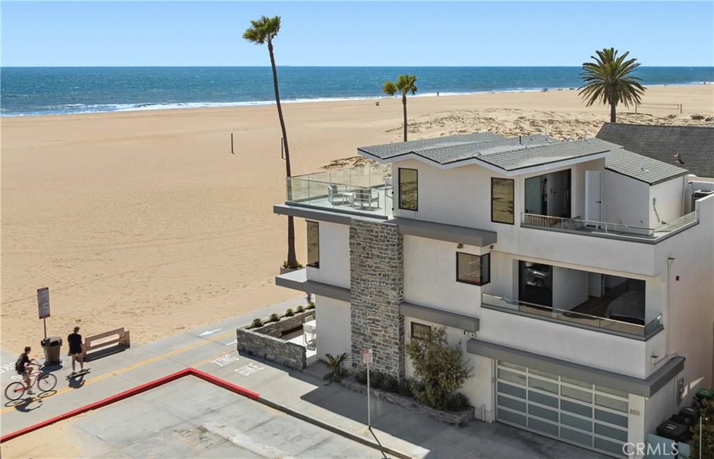 **Dream Location on the Sand with Breathtaking Views!** Welcome to this exquisite, fully furnished beachfront home that offers an unparalleled lifestyle of comfort and sophistication. Located on a sought-after corner lot in the heart of the peninsula, this beautifully constructed new-build, completed in 2019, provides the perfect blend of modern design and coastal charm. This is the ultimate sanctuary for those seeking walkability, privacy, and stunning views; This home is available for monthly, seasonal, or annual lease. Perched between two iconic piers, the residence boasts sweeping ocean views from every room across all three floors. The rear verandah overlooks the prestigious Newport Harbor Yacht Club (NHYC) and the sparkling lights of Fashion Island. Enjoy unobstructed vistas of the coastline stretching to Dana Point, with Catalina Island and the pier in full view. Each room is designed to showcase the serene beauty of the Pacific Ocean, providing an ever-changing canvas of ocean hues and sunset skies. Inside, the open-concept design flows seamlessly, highlighted by Fleetwood sliding doors that invite the outdoors in. The two luxurious master bedrooms are situated directly on the beach, each offering its own private retreat with ensuite baths and panoramic ocean views. The additional bedroom also features an ensuite bath, ensuring maximum privacy and comfort for family and guests. The state-of-the-art kitchen is equipped with a Wolf range and top-tier appliances, making it perfect for gourmet cooking and entertaining. A dedicated beachside patio, complete with a cozy fireplace, ceiling heaters, and built-in speakers, offers an ideal space for relaxation or hosting gatherings, while the BBQ makes outdoor dining enjoyable. For those focused on wellness, the third-floor gym, sauna, and full bath provide a serene space to unwind and rejuvenate. The property also features an elevator for easy access to all levels, and a water filtration system ensures fresh, clean water throughout the home. The volleyball courts on the beach add an extra layer of recreation and relaxation right at your doorstep. Available for immediate occupancy, this rare opportunity to live in the heart of Newport Beach awaits.