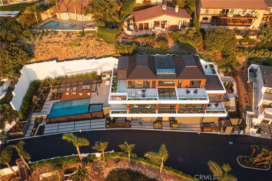 Behold this rare Laguna Beach compound. From the minute you ascend through the waterfront hillside onto this gated, striking estate in Laguna Beach’s coveted Temple Hills, you will know your destination is an architectural masterpiece created by the renowned Anders Lasater. Mindfully and deliberately designed with impeccable attention to every detail, the clean lines and cohesive blend of elements and textures will draw you in. With panoramic ocean views spanning to Catalina and beyond, this immaculate property is one-of-a-kind. State-of-the-art construction showcasing handcrafted and custom lighting, technology, accents and fixtures from the finest vendors around the globe comprise every inch of this home. Sleek lines and perfect angles measured with concise precision enhance the exceptional features of this grand estate. Rich walnut stairs juxtaposed against limestone floors complemented with gold and black fixtures create a perfect blend of Hollywood Hills Chic meets Contemporary Coastal warmth. This home is more than a house, it’s a work of art. Each room was curated and designed to maximize the space, energy, and the gorgeous vistas from every window. Skylights bring in even more natural light. Sit poolside and take in the striking view where the tranquil infinity pool appears to flow directly to the Pacific. This home evokes the feeling of being at a private five-star resort with exceptional landscape designed by Michael Wilkes. Pamper yourself every day and marvel in the majesty and serenity of 648 Canyon View.