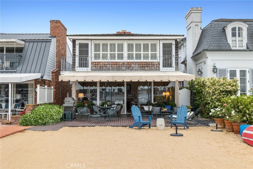 Introducing 1411 East Bay Avenue, an extraordinary bayfront residence entering the market for the first time. Located along a highly coveted stretch of Peninsula Point, this captivating waterfront home boasts a traditional charm felt throughout its sunlit rooms adorned with tasteful finishes. The main level features a gracious living room with a beautiful fireplace looking out to panoramic views of the private sandy beach, dock, and bay. With 4 bedrooms, the thoughtfully designed floor plan includes one bedroom downstairs and a large-scale master suite upstairs complete with a cozy fireplace, a wall of windows overlooking the Harbor, and a private balcony with views as far as the eye can see. The expansive bayfront terrace is the perfect setting for year-round indoor/outdoor living and is the ideal venue for entertaining on the bay. This landmark property also includes a two-car garage and a shared pier leading to a private dock with room for a boat and side tie, ensuring easy access to the bay for water activities. Enjoy a short walk to the Wedge, the harbor entrance, the Balboa Island Ferry, Balboa Fun Zone, and some of Southern California’s best beaches. A perfect full time residence or beach getaway - don't miss out on this market debut and the opportunity to own in an unparalleled location.