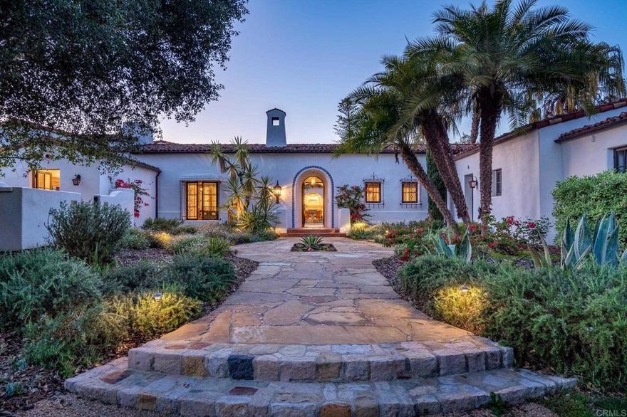 Casa Contenta:  Escape to paradise at this breathtaking custom Covenant compound in Rancho Santa Fe, where serene outdoor living and casually sophisticated interiors unite in a home that many will only ever dream of. Private and alluring with gorgeous west-facing sunset views, the gated 3.34-acre estate is a study in beauty and design, with richly detailed main and guest residences showcasing the talents of architect Steve Sharratt and colorful grounds that reveal a tranquil lily pond, towering trees, verdant lawns and drought-tolerant plantings. A greenhouse and raised vegetable gardens promote healthy sustainability, and a pool, spa, courtyard, and an array of patios and terraces provide endless opportunities for entertaining. Old World-style wood ceilings crown expansive living spaces in the hacienda, which extends approx. 10,287 s.f. and is home to 6 bedrooms, 7 full and 3 half baths, and vast living, dining and family rooms. The kitchen and baths shine with spectacular hand-painted tiles in an array of colors. Christened Casa Contenta, the gracious estate hosts a stunning kitchen with fireplace-warmed sitting area, a breakfast room and high-end appliances. A fireplace also enriches a master suite with sitting area, private patio, jetted tub and a walk-in shower.