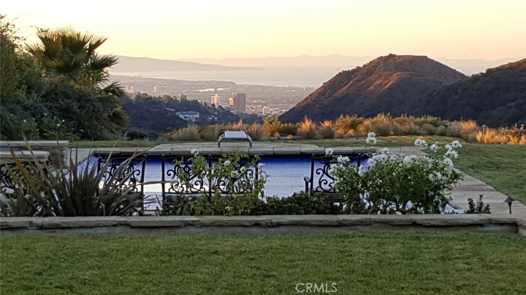 Custom built in 2007 with the highest quality materials, this Mediterranean-style Villa sits at the top of the mountain of Bel Air Crest, with spectacular views of the canyons, coast, and Catalina.
The Villa is designed around an interior courtyard setting, complete with fireplace and fountain. Once inside, the gourmet chef's kitchen features a commercial grade 10 burner stove, a stand alone wok, 3 ovens, and 3 refrigerators - perfect for large dinner parties. The kitchen flows into the family room and outside patio which overlooks the backyard pool and view to the ocean.
The Villa is complete with it's own 5000 bottle wine cellar (a wine lovers dream), a movie room, playroom/lounge, separate guest suites, elevator, and more.