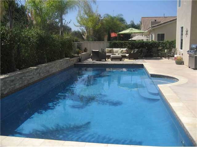 Executive home on large lot at the end of the cul-de-sac. This upgraded home features, distressed hardwood floors down, upgraded carpet up, granite counters with a large center island in the kitchen and an eat-in breakfast area, that is open to the family room with a fireplace and built in entertainment center, over looking the large pool and spa and private hillside behind. The large living room and dining room over looking the pool with French doors leading from the dining room out to the pool.SEE SUPP. Bedroom 5, currently being used as an office,(no closet), is downstairs adjacent to a full, fully remodeled bath. The master suite with large walk-in closet is upstairs with the other three bedrooms. There is a loft at the top of the stairs that is ideal for an office/hobby space, or a additional, separate lounge area. The living area, master bedroom and two of the three upstairs bedrooms face to the southwest for an abundance of light during the day. The home boasts designer colors, ceiling fans throughout, air conditioning, three car garage, and much more. The home is near Ashley Falls school, convenient to both high schools and easy access to Carmel Valley Middle school, shopping churches, restaurants and entertainment, Hwy. 56 and I-5. Tenants will love this home, end of cul-de-sac, large pool, large grassy area, very private, 5 bedrooms plus a loft. Tenants are encourage to take a look and imagine enjoying the Carmel Valley Lifestyle on Pearlman Way. Available immediately.Welcome home. Neighborhoods: Palma Del Mar Sewer: Sewer Connected