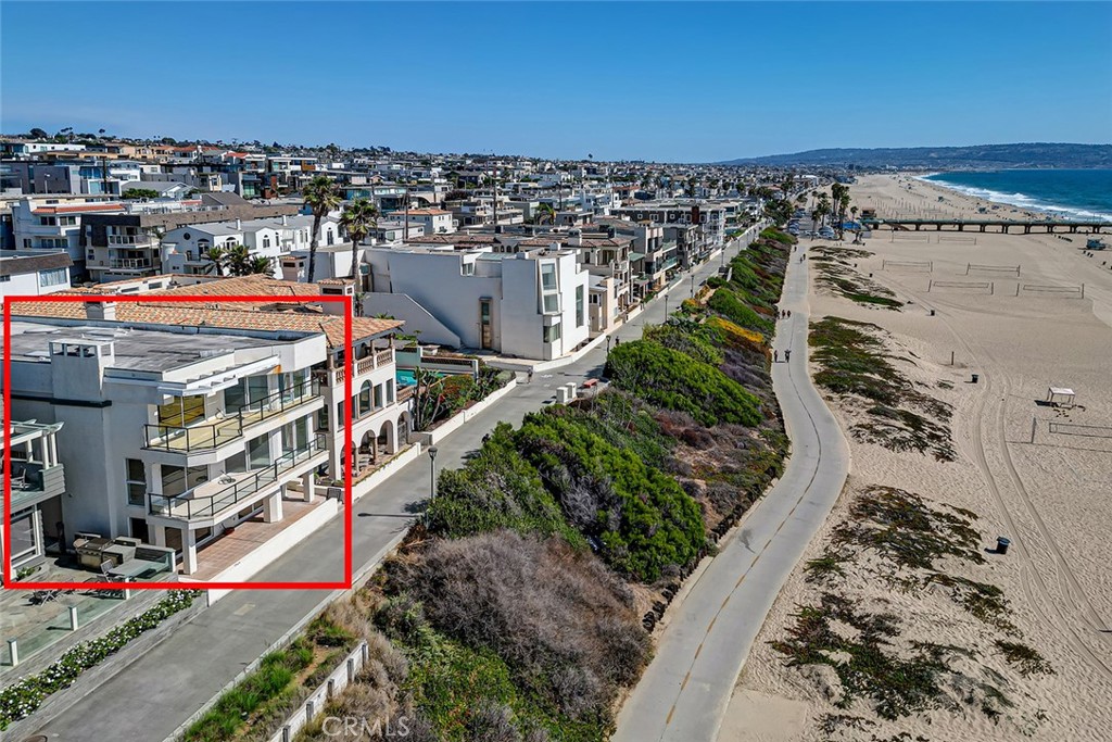 Introducing 1508 The Strand, situated in one of the most idyllic locales along Manhattan Beach’s golden sands. This lot offers not just a home but a true lifestyle. Featuring five bedrooms and five and 1/2 baths in 5589 square feet on a 3329 square foot lot, the possibilities are as endless as the stunning views. Originally built in 1988, this residence is a canvas awaiting your dream home, whether you choose to reimagine the current structure or build from the ground up. Upstairs, the vast Primary Suite is an owner’s dream, with glass walls looking out onto the Pacific and a protected private balcony. Imagine waking up to the sound of the waves each day, then basking in the luxury of your own private oasis with two luxurious baths and two spacious walk-in closets. Two additional bedrooms on this level share a large, sunny deck and were designed with custom built-ins and cedar-lined closets, with a shared neighboring bath. Just down the hall, you'll find the added convenience of an elevator and a dedicated laundry room. The center floor is home to a sizable great room with high ceilings, a cozy fireplace, and arresting ocean views, as well as a glass-walled balcony. The kitchen takes advantage of the sand and sea landscape from a pass-through with charming, shuttered doors, and offers plenty of countertop and storage space, a separate pantry, SubZero refrigerator, and a cooktop island. A nearby powder room is perfect for visiting friends and family. Take the winding staircase to the Strand level, where a generous beach room with Saltillo tile flooring and a wet bar encompasses the entire width of the floor and opens onto the Strand. Two bedrooms and a full bath also boast Saltillo tile and create the feeling of being on vacation every day. A large bonus room with considerable storage and significant cabinetry would be ideal as an office or custom gym. Additional amenities include a four-car garage, an incredible view of the iconic Manhattan Beach Pier, and a 5-minute stroll to the vibrant shops and restaurants of downtown Manhattan Beach. With unrivaled ocean views, this is the ultimate blank slate for those with a passion for design and a vision for luxury. Create the custom coastal masterpiece you’ve always dreamed of in one of Southern California’s most coveted locations on the Strand in Manhattan Beach.