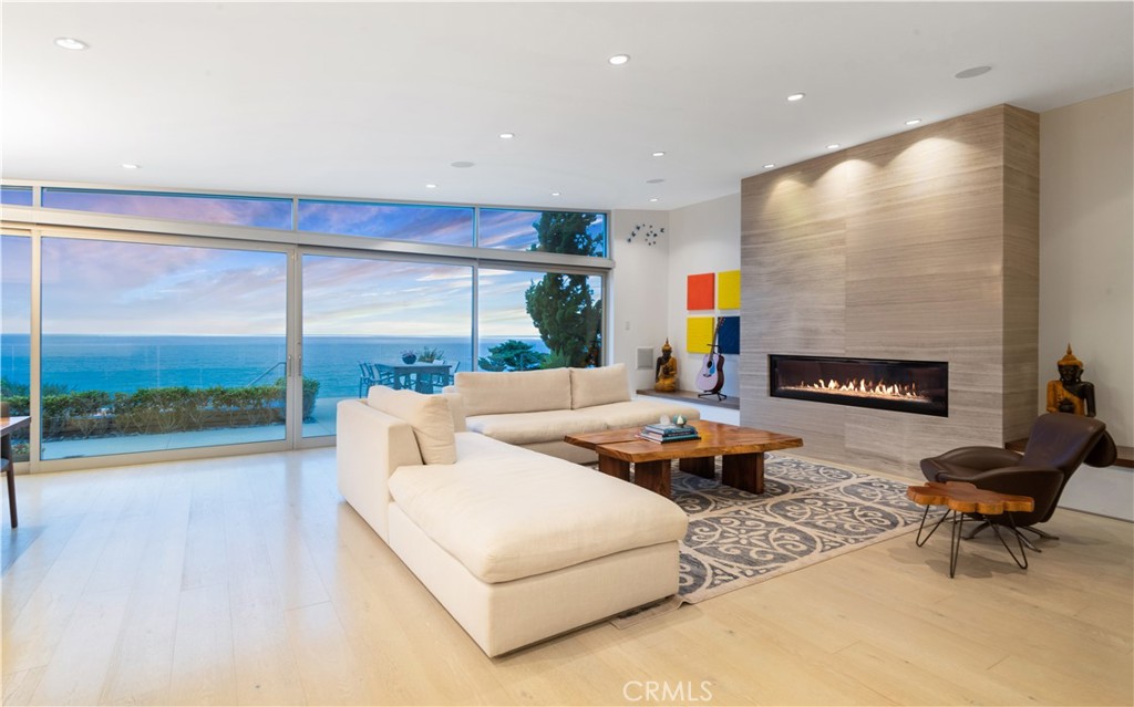 Nestled into the verdant, Riviera hillside, this tri-level, bluff top home offers unobstructed, panoramic ocean views from Palos Verdes to Malibu and beyond! Begin and end each day to the sound of the surf, the smell of the ocean and unparalleled views of the beach, sand, whitewater and the Santa Monica Bay. A private courtyard entry buffers the outside world. The Zen interior boasts vaulted ceilings and walls of glass doors which blur the lines between inside and out. The chef’s kitchen, a dramatic living room and adjacent dining area all enjoy panoramic vistas. Just outside, multiple patios include a fire pit, BBQ and captivating pool & spa. Cascading down the hillside, the lower level yard unveils a beach bungalow, fire pit and expansive sand area. Solar panels, radiant heating, and a spacious two car garage with ample driveway are just a few of the amenities. Moments away from the many shops and restaurants in the Riviera Village, opportunities like this are few and far between.