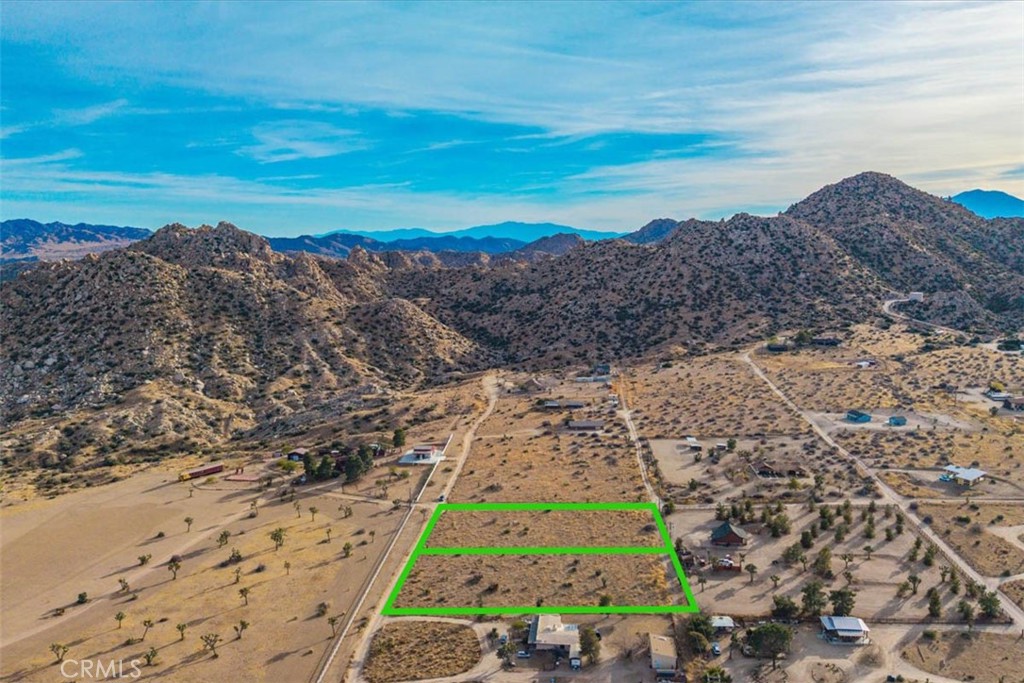 Discover an extraordinary opportunity to own in the heart of Pioneertown. These two spacious vacant buildable lots (one with a paid water meter) are situated just a short walk from the iconic Pappy & Harriet's and other historic sites, offering both convenience and charm. Surrounded by stunning natural landscapes, the property provides an ideal setting for building your dream home with breathtaking views of rugged desert mountains. Whether you're looking for a tranquil escape or a vibrant spot near Pioneertown's lively cultural hub, this parcel of land is a rare gem waiting to be transformed into something truly special. Don’t miss your chance to own a piece of this iconic desert paradise.