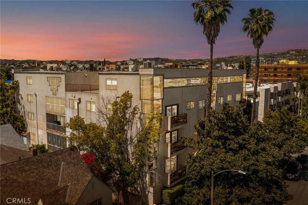 Been looking for something special to come on the market? Check out this spectacular tri-level corner unit penthouse in the highly desireable Pico-Robertson neighborhood of LA. Pull up to your modern yet classic mid rise, park in your spacious tandem spot, take the elevator up to the top floor and step inside this spectacular home and you will be wowed by the soaring 19' ceilings, Art-Deco windows, the grand fireplace, cool parquet floors, a gorgeous chandelier and views from every room. This penthouse covers 3 levels and has 2 separate entrances. The grand 2 story living area and kitchen is located on the main level. Retreat downstairs and you will find the two suites separated by the hallway. The primary suite is an oasis in itself, has a spa-inspired bathroom that includes a deep jetted tub and a separate walk-in stone with an enclosed glass shower and two walk-in closets. The secondary suite on the other side of the hall offers privacy if you need it. This bedroom also has a walk-in closet and an en-suite bathroom with a glass enclosed walk-in shower. This suite also has a nice private balcony overlooking the beautiful Magnolia tree out front. Need some separation, head up to the top floor and you will find the loft that is currently being used by the owners as a home gym. This level also has access to the roof with great views of DTLA and the Hollywood Hills. The top floor also has another spacious room that is perfect for that stay at home office or a 3rd bedroom for your guests. This home has lots of charm, gives you space to spread out, has been refreshed and maintained very well by the current owner. Looking for that special retreat from the hustle and bustle of LA, but want to be close to it all? This could be the one you have been looking for. Plus Professional Management, Low HOA and a good deal for a nice building. Close to all the shops, dining entertainment on Pico and Robertson and the new purple line extension that is under construction at Wilshire and La Cienega. Schedule a tour with us today.