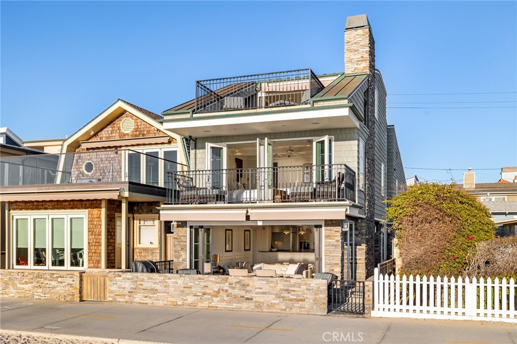 Stunning custom Oceanfront home with spectacular views of the ocean, Catalina, Newport Pier, and more! Situated on a beautiful Oceanfront lot, this picturesque Cape Cod design was rebuilt in 2008, offering three bedrooms plus a bonus room on the third floor, five baths, a fantastic floorplan, pristine details, and some of the best views around. The first floor offers a large open great room with bi-fold doors out to an outstanding front patio, fireplace, and a gourmet kitchen with Island and walk-in pantry. The second floor provides a spacious master retreat with breathtaking views, custom ceiling detail, and a model-like bath with dual sinks, walk-in shower, and closet. The balance of the second floor offers two more guest suites, one of which could function as a second master with vaulted ceilings, laundry, and more. The third floor has a large bonus room with built-in bar, refrigerator, bathroom, bonus storage area or playroom, and bi-fold doors out to an eye-catching and spacious roof deck with unmatched views. The home also comes with a large two-car garage with extra fridge, secondary laundry, and carport with space for two additional cars. Turnkey homes like this on the oceanfront are rare. This one won't last long!