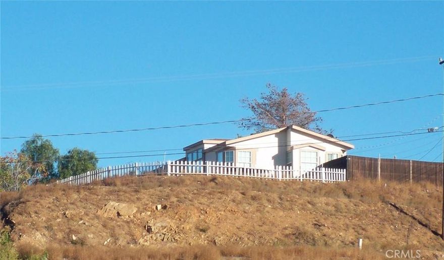 Top of the hill! Manufactured home on over 1/2 Acre. Views & views & views! Large home with 3 bdrms, 2 ba, eating area and island in kitchen, plus a dining room. Large Pantry in Kitchen. Separate Laundry Room.  This home is very spacious, lots of room for toys and critters.
