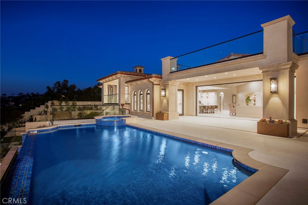 Situated on one of The Strand’s largest homesites, measuring nearly half an acre, this exquisitely designed classic Mediterranean villa offers breathtaking ocean panoramas and gorgeous Catalina Island sunsets. Constructed with the highest attention to detail and the finest finishes and fixtures, this spectacular 5 bedroom, 7.5 bath residence is reminiscent of the grand estates found in Italy. A circular drive and the only porte cochère entry in the community set the stage for the grand estate that awaits. Beyond the foyer, an expansive great room and chef’s kitchen offer magnificent ocean views and a seamless transition to the spacious loggia for embracing the indoor outdoor lifestyle. Flowing from the great room, the formal dining room and living room create the perfect floor plan in which the majority of living takes place on the main level. Also located on the main level, the estate’s ocean view master suite opens to an elegant veranda with direct access to the pool and spa. Additional highlights of this 3-level home include a Butler’s kitchen, walk-in wine cellar, theater/ media room, dry sauna, and outdoor kitchen. Located in The Strand with resort-like amenities and a short stroll to the beach, this exquisite estate is beyond comparison.