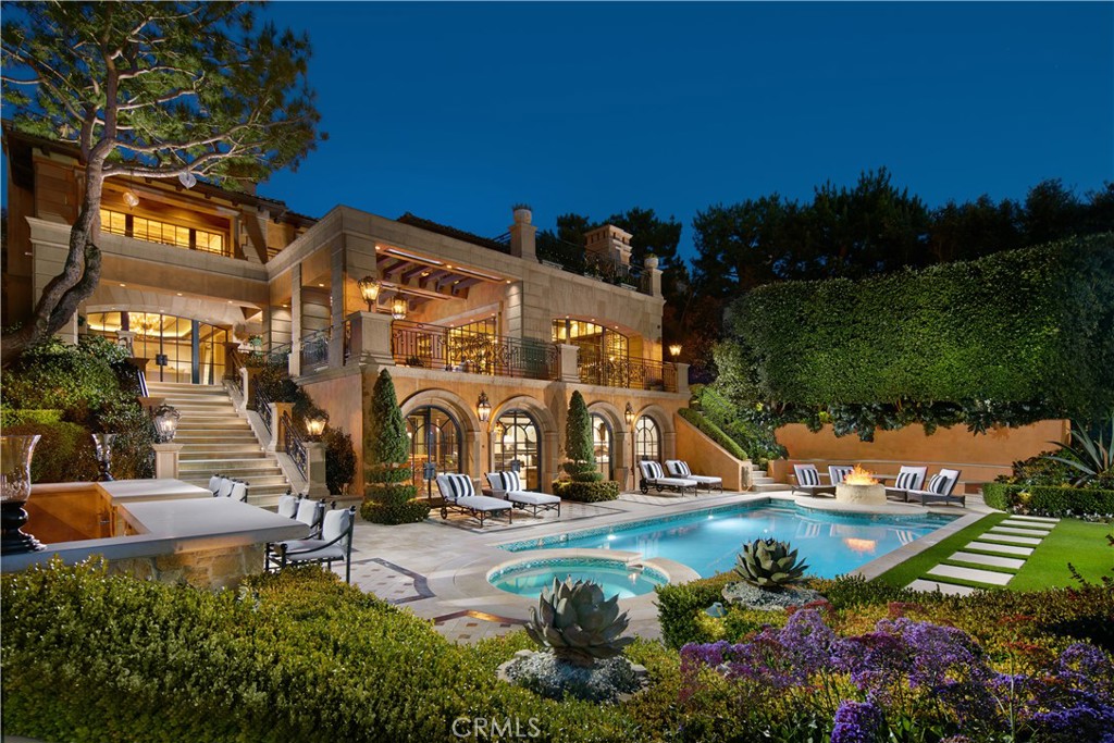 Graced with an impressive provenance, 34 Pelican Crest is an incomparable recreational retreat combining Mediterranean revival style with Italian elements. The stately appx. 12,525 SF residence commands vistas of the ocean, harbor, and golf course, as well as the estate’s gardens, salt-water pool, spa, custom stone fountains, and sweeping lawns from multiple verandas. Complementing the stunning architecture are antiqued mirrored ceilings, marble floors, custom iron doors, limestone walkways with inlaid mosaics, Venetian plaster and JP Weaver Molded Ceilings with 24K gold, and stone walls, creating an idyllic resort-like environment for entertaining, both indoors and out. The exceptional gourmet chef's kitchen offers blue Esmeralda quartz countertops, a custom 1,068-bottle wine cellar, with Subzero, Dacor, & Miele appliances. Furthering the allure of the property are a wellness area with wet and dry saunas, swanky entertainer's lounge area overlooking the indoor basketball court, billiard room, theater with Dynaudio speakers & Krell amplification, appx. 2,765 SF 12-car garage with racing simulator, a custom slot car track, and a private casita. Additional amenities include a newer digital projection Hi-Lite laser 4K projector, 4K TVs, Ruckus Wi-Fi system, & a full Crestron home automation system controlling lights, HVAC, shades, A/V, pool, fountains, and security cameras. Enjoy this coveted lifestyle with world-class golf, shopping, and beaches just moments away.