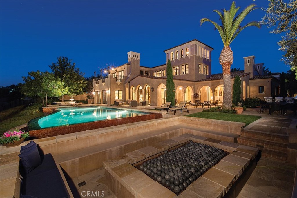 Bask in the elegance and luxury of quintessential coastal living within this custom Crystal Cove estate located off the coveted High Water street . With views as far as the eye can see of the Pacific coastline, sunsets over Catalina, and Newport Harbor, this estate offers everything one would want from a seaside abode. The recently completed estate lends itself to vast square footage of living space with 7 bedrooms (2 master suites) 7.5 bathrooms, wine cellar, home theater, library, 4 fireplaces throughout, and sliding doors that lead you out to the ocean facing back yard. Once outside in the back drop of the endless Pacific Ocean with Catalina island resting on the horizon, you can indulge in the vast amenities which include, saline custom tiled pool, BBQ pavilion, and outdoor bar, large sunken fire pit with benches on all sides all surrounded by well appointed hardscapes and landscapes. No detail was left unattended to, from the hand carved lime stone fireplaces and mantels, to the venetian plaster that coats the interior and custom millworks throughout. 29 High Water is the epitome of value and luxury within Newport Coast.