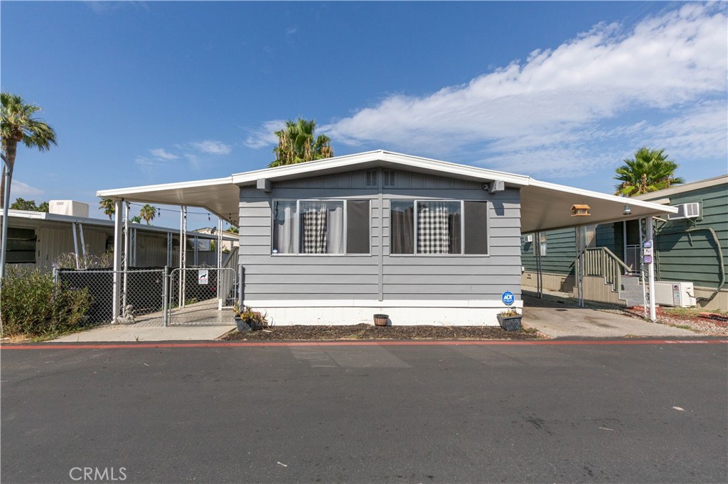 ** Back on Market! Buyer could Not Perform! **
Welcome to quiet Santa Rosa Mobile Home Community! As you enter the home, you will find laminate flooring thrughout, two wall A/C units as well as central A/C and heating, a living room with plenty of natural light, as you continue to the dining area, there is a built in cabinet and ceiling fan, the kitchen is also equipped with an oven and microwave, stainless steel dishwasher, along the clean and beautiful white countertops and cabinetry. right next to the kitchen you will find the laundry room with access to the cart port. Next, you have the guest room with a guest bathroom. Down the Hall, you will enter into the Master bedroom, equipped with double mirror doors closet, as well as, an amazing vanity right next to The master bathroom. You can also enjoy a fully shaded patio and a two car parking port and a small backyard. Conveniently close to parks, shopping centers, Echo Hills Golf course, Diamond Valley Middle school, and Domenigony parkway! park approval needed, Space Rent $700, Community has two pools, clubhouse and gym. buyer do your due diligence. Raise your family in a safe community, Don't miss out, schedule your appointment now!