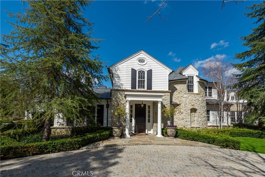 Sited behind private gates, this beautiful, and fully furnished custom estate totals approximately 12,231 square feet of true luxury living. Step through the entry door into a world of quality and elegance. Every inch of this model sharp home shines. Highlights of the main house include a large downstairs primary suite with a retreat, dual baths, and dual custom closets, plus there are five additional en suite bedrooms, a gorgeous center island chef's kitchen, both a big breakfast room and a formal dining room, a spacious family room & game room, an entertainer's lounge with wet bar, refrigerated walk-in wine cellar, custom office, bonus room, and a sunny living room that opens to a covered dining patio that includes an outdoor theater area with cozy fireplace, all overlooking the spacious grounds. Additional property amenities include a beautiful detached gym with bath, steam shower and it's own adjoining spa, a large private guest house complete with a full kitchen, fireplace, and an additional bedroom and bath, two covered patios, a sparkling pool & spa with multiple waterfalls, expansive lawn areas, lush privacy landscaping, and a seven-car garage complete with four additional lifts for a total of 11 spaces. The home has also has a comprehensive new home automation system, gated driveways, and lush privacy landscaping, all on a expansive flat lot. If you've been waiting for something special, this is a truly beautiful home from start to finish. (The measured square footage includes the main house, guest house, and the detached gym house).