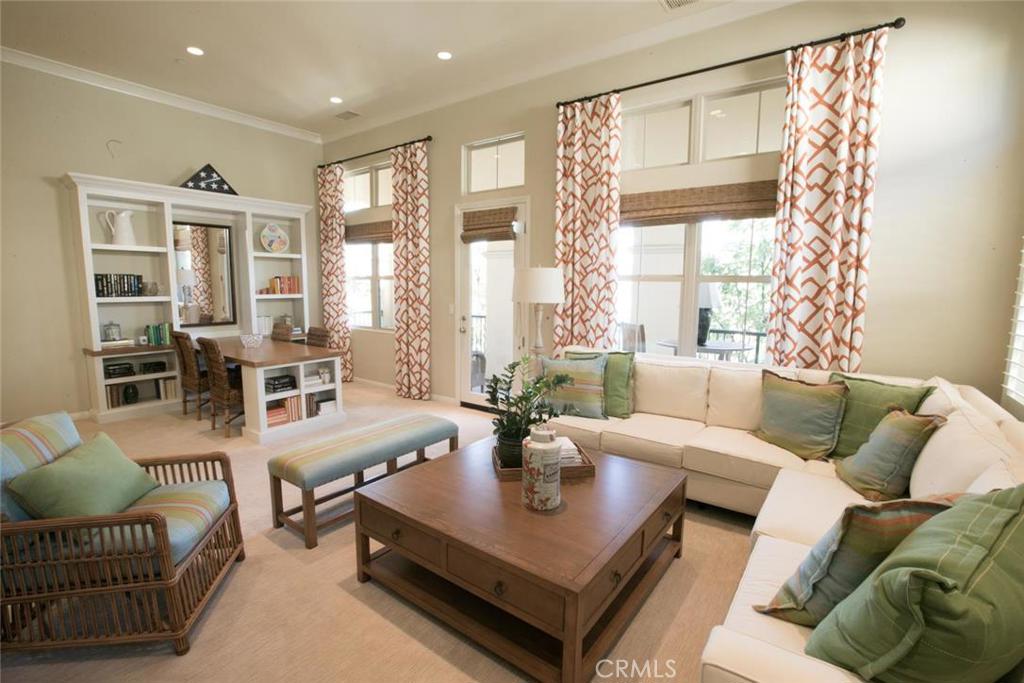 Beautiful Former Model home. Great end unit location with guest parking near by. Turnkey and upgrades galore. Custom upgraded tile entry and plush carpeting on stairs leads to upstairs with open and spacious one level of living space. Gourmet kitchen with Quartz counter top, designer tile on back splash, Whirlpool Stainless appliances, upgraded cabinets and upgraded tile flooring. Great room with plush carpeting, built-in entertainment center, built-in dining table and bookcase. French door from great room opens to large deck perfect for outdoor space and entertainment. Master bedroom has walk-in closet with custom closet organizer. Master bath with dual vanities, quartz counter and designer tile back splash as well as upgraded tile flooring. All bedrooms have can lights on ceiling. Two car attached garage with built-in cabinets and upgraded epoxy flooring. The association offers parks, sport courts, swimming pools. spas.