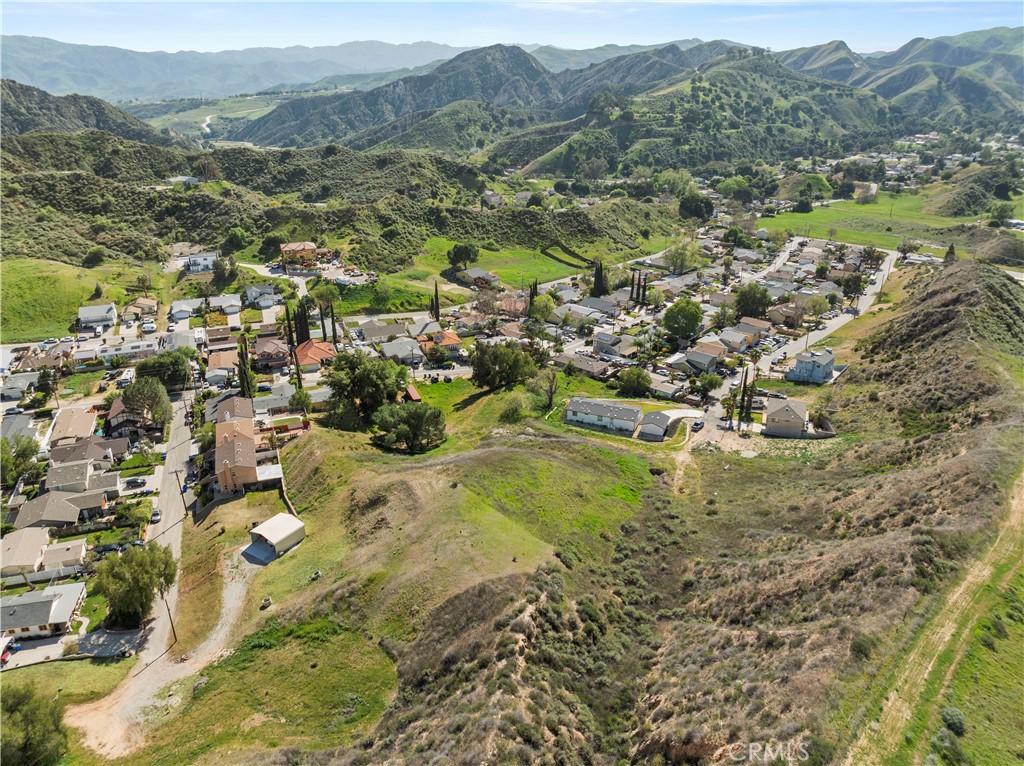 Incredible opportunity to own a residential lot with mountain views in the peaceful Val Verde community. Tucked away at the end of a cul-de-sac atop a private knoll, this property offers privacy, natural beauty, and endless potential. The adjacent parcel is also available, bringing the combined total to approximately 0.85 acres (36,451 sq ft)—ideal for building the home you’ve always imagined. Utilities are nearby. Enjoy the charm of a small-town atmosphere while staying close to the conveniences of Hasley Canyon and Santa Clarita. Minutes from Six Flags Magic Mountain, hiking and horseback trails, the community park and pool, and just a short drive to Castaic and Piru Lakes. A rare blend of rural serenity and accessibility—come see it for yourself! Seller is open to carrying a note.