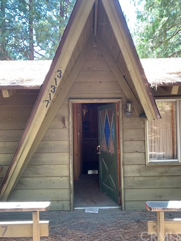 EXCELLENT OPPORTUNITY for any investor or personal home in the popular mountain city of Running Springs. You can instantly envision the potential design upgrades upon entering the property. Nestled in the surrounding pine and cedar trees, this location feels very private. Features of this home include a spacious kitchen, large brick fireplace, high ceiling with amazing and coveted wood beams with natural tongue and groove boards, large upper wood deck, and has natural gas with city sewer services. Composition roof was installed within the last 5 years. This location in the desired Upper Rowco neighborhood, is close to all of the adjoining cities including Lake Arrowhead, Blue Jay, Twin Peaks, Crestline and Lake Gregory. Big Bear is just 20 minutes away. Santa's Village/Sky Park, shopping, restaurants, Snow Valley Ski resort, Jensens market are all minutes away. Property is a fixer, and sold in as is condition. Cash only buyers.