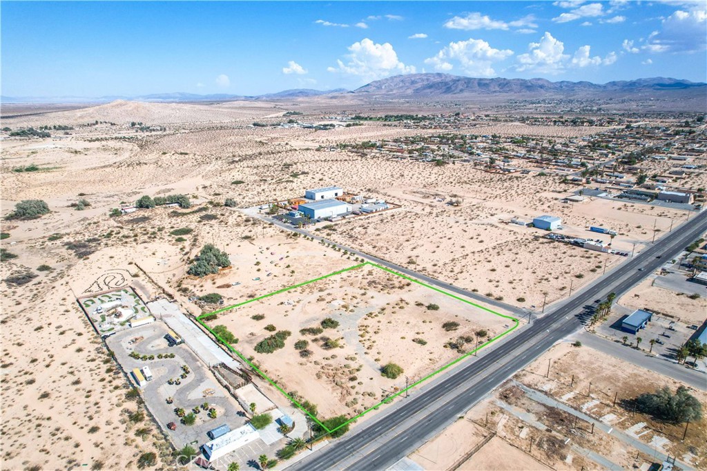 This 4.45-acre parcel in 29 Palms is a versatile opportunity awaiting your vision. Zoned for Industrial, Commercial, and Residential use, the possibilities are vast—allowing for nearly any business venture. Nestled along historic Adobe Road, this prime location combines character with potential. The property is already connected to city water, featuring a 5/8" water meter, streamlining your setup for development if you upgrade to a 1" water meter. While overhead electrical utilities may need to be underground (to be confirmed with City Hall), this parcel's flexibility and location make it a standout choice for investors, entrepreneurs, or anyone looking to build something unique. Don't miss out on this gem in the heart of 29 Palms!