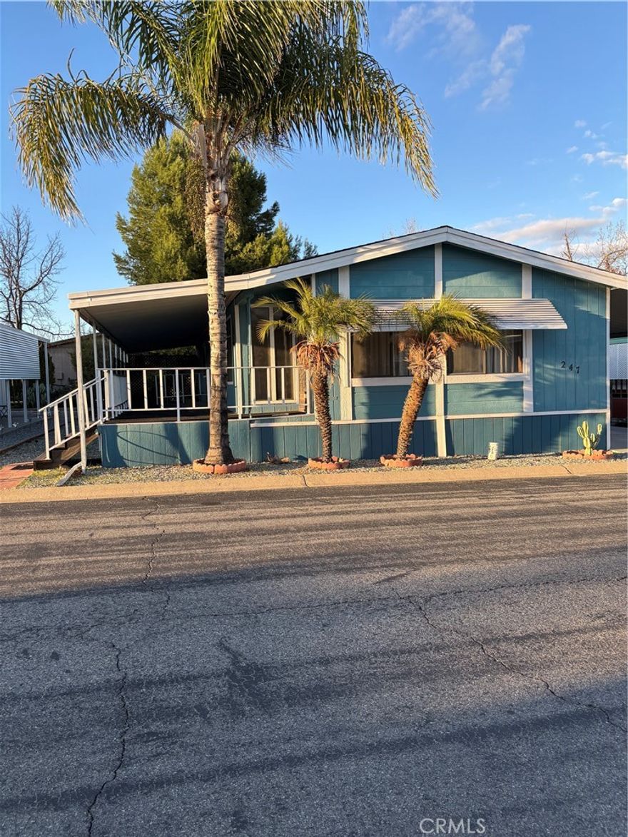 Desirable Hillside Mobile Home Estates, a 55+ community in Menifee, CA 92586. 2-bedroom, 2-bathroom. Nestled on a spacious lot, this move-in-ready property open living space with stylish upgrades throughout. Step inside to find soaring beamed ceilings, abundant natural light, and a welcoming living room that flows seamlessly into the formal dining area. The generously sized bedrooms include large closets. Laundry room with a utility a table convenience. Outside, the attached carport provides covered parking, and a detached shed offers extra storage or workshop potential. Residents of this vibrant community enjoy a clubhouse, billiards room, and refreshing pool. Conveniently located near shopping, dining, and major freeways.