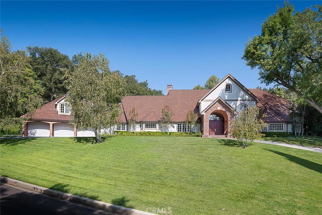 Stunning Royal Oaks English Manor estate on apx 1.3 acres of parklike grounds w/184 ft. frontage & circ driveway. Extensively rebuilt, remodeled and expanded to almost 9,000 sq. ft. in 2003-05. Dramatic 2 sty foyer w/crystal chandelier & elegant curved staircase. Hdwd floors extend throughout the grand scale entertaining rooms w/voluminous ceilings. LR w/floor-to-ceiling cast stone frplc. Adj media rm w/projector, screen, wall of built-ins, frplc. Banquet sized FD. Chef’s kitchen w/lg center island, granite counters, 2 DW’s, walk-in pantry. Wolf, Sub Zero & Miele appl. Kitch opens to FR & Jr. DR w/floor-to-ceiling frplc flanked by lighted glass shelving. 2 en-suite bdrms on main level, one of which is second master. A powder rm, laundry rm & utility room complete the main level. Upstairs there are 3 en-suite bedrooms. Spacious master suite w/wall of built-ins, frplc, luxurious ba w/steam shower, spa tub, enormous walk-in closet. Guest suite over 3-car garage w/LR, bdrm, ba & balcony. Lush rear grounds w/mature trees, pool, BBQ pavilion, extensive decking, lighted NS TC. 5 zoned HVAC, Lutron lighting. Lanai Rd Elem. & Hesby Oaks Middle School w/close proximity to Ventura Blvd shopping, restaurants, and easy Westside access.