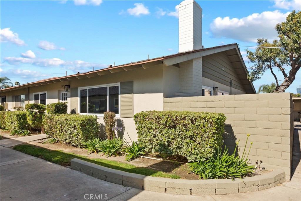 Newly renovated end unit, single story, with an oversized outdoor patio! This fabulous home is granted two covered parking spaces adjacent to the property. Inside laundry hook ups have been added along with a brand new air conditioning unit. New wood grain luxury vinyl floors, recessed lighting and dual pane windows are carried throughout. Your new kitchen features white shaker cabinetry, stainless steel appliances and Quartz countertops. The open concept floor plan transitions from the casual dining area to the family room with a gas burning fireplace. Your primary bedroom is very spacious, offers great closet space and delivers a newly remodeled primary bathroom with a glass enclosed shower cased in designer tile. Two generously sized guest bedrooms share a fully upgraded guest bathroom with a bathtub. The sundrenched outdoor patio spans the width of the house offering a concrete patio area, a mature tree and landscape for planting or grass. Additional features include: A community security gate, association inground pool and new water heater!