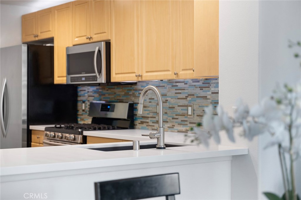 Within the gated community of Watermarke, one of the most pristine and resort-like communities in Irvine, you will be pleased to find this third-floor unit overlooking an impeccably kept, and forever green courtyard with a perfect park-like atmosphere. The Gramercy Park floor plan features 2 bedrooms with walk-in closets, and 2 remodeled bathrooms. Completely redone to incorporate smart home capabilities, with a keyless entry pad, Nest smoke detectors, LED recessed lighting, new paint throughout , waterproof plank flooring, premium carpet, and a Ecobee thermostat; all this unit is missing is a new owner. The kitchen includes newer Samsung stainless-steel appliances, new quartz countertops, and a stunning backsplash; opening to a bright and airy dining and living spaces with a private patio allowing the best of the afternoon light. Completed with in-home laundry, which includes the washer and dryer; 2 garaged parking spaces, no Mello roos, and low tax rate – 2337 Watermarke is the perfect home for you! Conveniently located in the heart of Irvine, near shops and prominent dining, Watermarke community features 3 pools with pool side cabanas, 4 spas, a fitness center, a basketball court, a tennis court, a club house, and a business center – so you never have to leave!