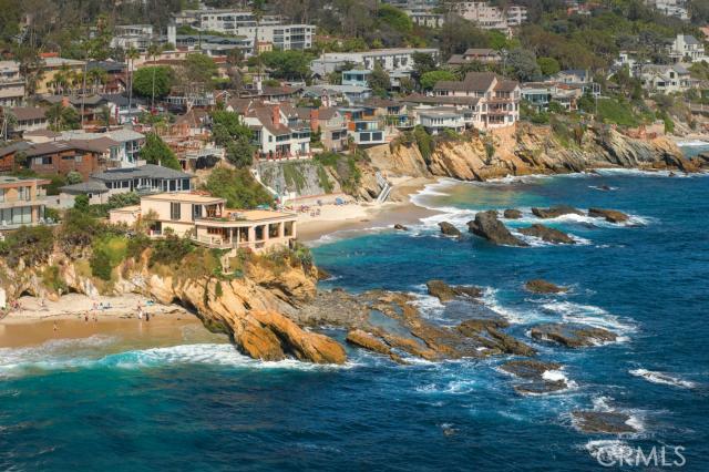 Occupying a singular oceanfront rock promontory known as “Arch Point”, this stunning seaside residence takes in views from the cerulean and azure waters that surround it on three sides. At one with its setting, the stylish Mediterranean villa is suspended at the water’s edge taking full advantage of the never-to-be-duplicated site. Wrapped in floor-to-ceiling glass, the magnificent ocean, island and coastline views seen from throughout are simply unmatched. It features expansive entertaining rooms – all opening through disappearing walls to broad limestone terraces set above the crashing surf. A full floor master suite features its own oversized terrace w/ 270-degree views and absolute privacy. Also included are a waterfront great room; an oversized dining room; two guest suites (one detached for privacy); a chef’s dream kitchen; an informal dining area; 5 large waterside terraces, and a wine cellar w/ tasting room. All of this is set behind a private gate, with a private motorcourt, hidden from street view. A private path to the beach includes yet another scenic overlook set just above the beach and tide pools. Exceptionally private, yet featuring the best views on this coast, no other home offers such an amazing setting for living and entertaining.
