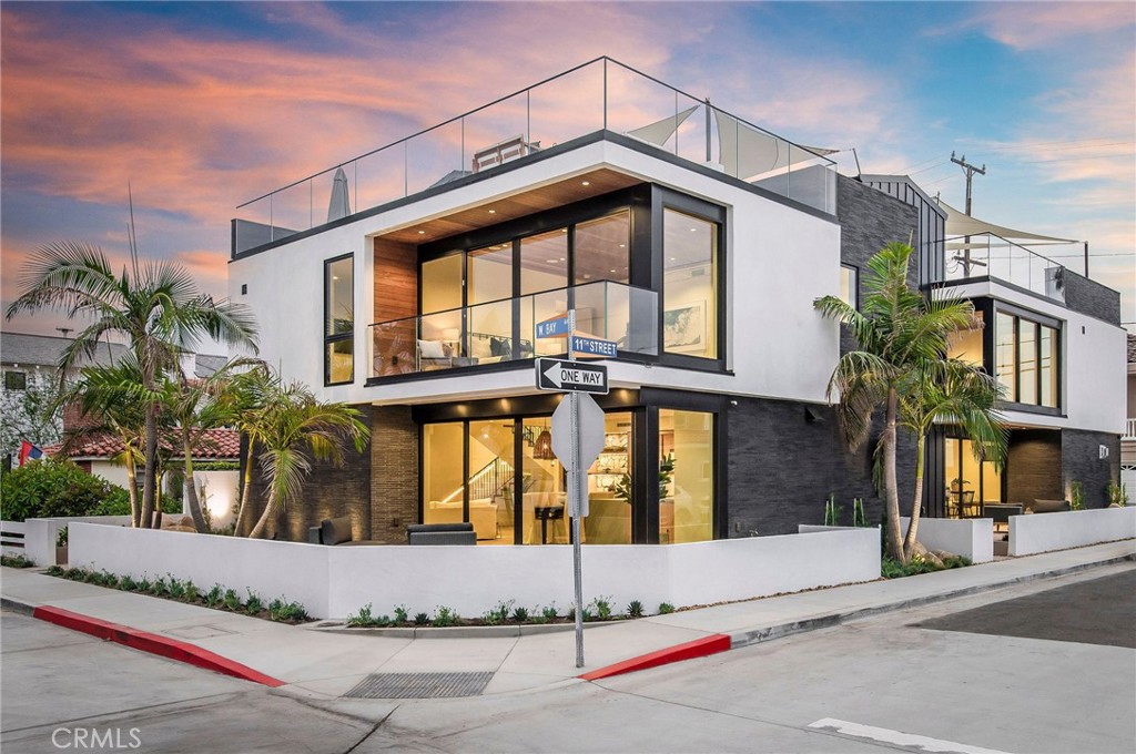 House A: Welcome to paradise on the peninsula nestled within the exclusive confines of Newport Beach. This home is an architectural masterpiece that captures the essence of the Tulum ambiance. Spanning an impressive 2,964 sqft of livable elegance, this stunning condo offers three spacious bedrooms with an option to transform the chic loft into a fourth sanctuary with an attached bath. Experience the luxury of an expansive deck boasting 981sqft, perfectly positioned for breathtaking bay and ocean views. Every detail is meticulously crafted to enhance your living experience. Revel in the warmth of the indoor-outdoor linear fireplace, or the culinary perfection of a chef's kitchen decked out in top-tier Dacor Appliances. A grand master suite welcomes you with a lavish bath, an oversized walk-in closet, and uninterrupted bay views, awakening the serenity in you. Experience the epitome of indoor-outdoor living with the majestic Fleetwood sliders that seamlessly lead you from the kitchen to a front patio adorned with bay scenes. Plus, a rooftop deck that becomes your personal sanctuary for sunsets and starry nights. Experience life at Newport Beach's finest – a corner lot on West Bay Ave, undeniably the most serene and private street on the peninsula. Located in the perfect nexus between the beach, bay, fun zone, and countless amenities, resort living is not a promise; it's a daily reality. Revel in unparalleled natural light, modern comforts like zoned central air, and an atmosphere that's forever vacation-esque. Come home to more than just a residence; it's a life of luxury and tranquility. House B is also available.