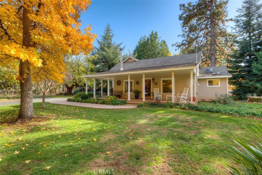 Build a life you don’t need a vacation from with this charming old farmhouse! Nestled in the serene community of Nimshew, this stunning homestead offers the perfect balance of rural mountain living while still being just minutes from shopping and amenities. As you arrive at the gated property, you’ll be captivated by the vibrant fall-colored trees surrounding the inviting country wraparound porch. The mature landscaping, koi pond stocked with over 30 fish, and multiple smaller ponds create a peaceful retreat right in your own backyard. This property is truly a gardener’s paradise, featuring a variety of mature fruit and nut trees, including apple, pear, cherry, fig, persimmons, plums, black and English walnut, pistachios, grapes, blackberries, and kiwi. There are also two fenced vegetable garden areas with irrigation to support your homegrown lifestyle. Inside, the charm continues with a cozy stone hearth surrounding a wood-burning stove. Over the years, the home has been thoughtfully updated, including electrical and plumbing improvements, as well as a beautifully remodeled kitchen featuring new cabinetry and granite counters—while still preserving the character of the antique Wedgewood stove. The master suite is conveniently located on the main level, with two additional bedrooms upstairs. Step out back to experience breathtaking landscaping, ponds, and a sparkling pool—your own private oasis. The 24' x 40' detached shop with 220v power is currently used as an art studio, home to "Mellow Mud Pottery," and there’s an additional structure serving as a gallery and office space. Both buildings offer endless possibilities for creative, professional, or personal use. Homes with this much character and opportunity are rare—don’t miss the chance to make this dream lifestyle your reality!