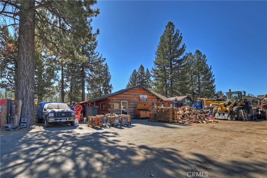 Prime Commercial Opportunity in Big Bear Lake! Three commercial buildings totaling 2,214 sq. ft. Versatile 1,248 sq. ft. full log office building, currently operating as a retail firewood business. Located on a spacious 40,788 sq. ft. parcel, this property is zoned C-2 Commercial General, making it ideal for various business ventures. The office features a welcoming reception area, two offices, a bathroom, and a kitchen, perfect for both client interaction and staff needs. The property includes a spacious warehouse/garage with dedicated workstations, and multiple storage sheds for added convenience. In a high-traffic area, this location offers excellent visibility and accessibility. The building boasts updates to the roof, plumbing, and electrical systems, all completed in 2007. Whether you're looking to expand your business or start a new venture, this property provides an ideal foundation in a thriving community. The business is not for sale and owner will have everything moved by close of escrow.