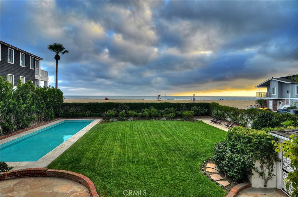 An extraordinary oceanfront estate opportunity that has resided in the same family since 1937. Highlighted by expansive ocean views, a broad verdant lawn and abundant mature foliage this warm, traditional-style beach home spans three contiguous lots and ninety-feet of water frontage. Sited on a corner parcel of over 11,300 square feet the timeless residence is positioned at the rear portion of the parcel – away from the boardwalk and benefiting from unquestionable privacy, a panorama of views, flowering gardens and an elegantly proportioned 55 foot pool. Rich with possibilities the property holds a Multi-Unit Residential (RM) zoning designation. Per the City of Newport Beach should the existing residence be demolished three individual lots as configured in the initial subdivision of this property would exist. One of the few remaining opportunities along the Southern California Coast to own a triple lot parcel with tremendous flexibility of use. Construct an unparalleled oceanfront compound. Develop multiple single family or duplex condominium residences. Re-envision the site as one larger multi-unit structure spanning three lots. Or enjoy the classic beach home that exists today. A legacy oceanfront property that is without peer.